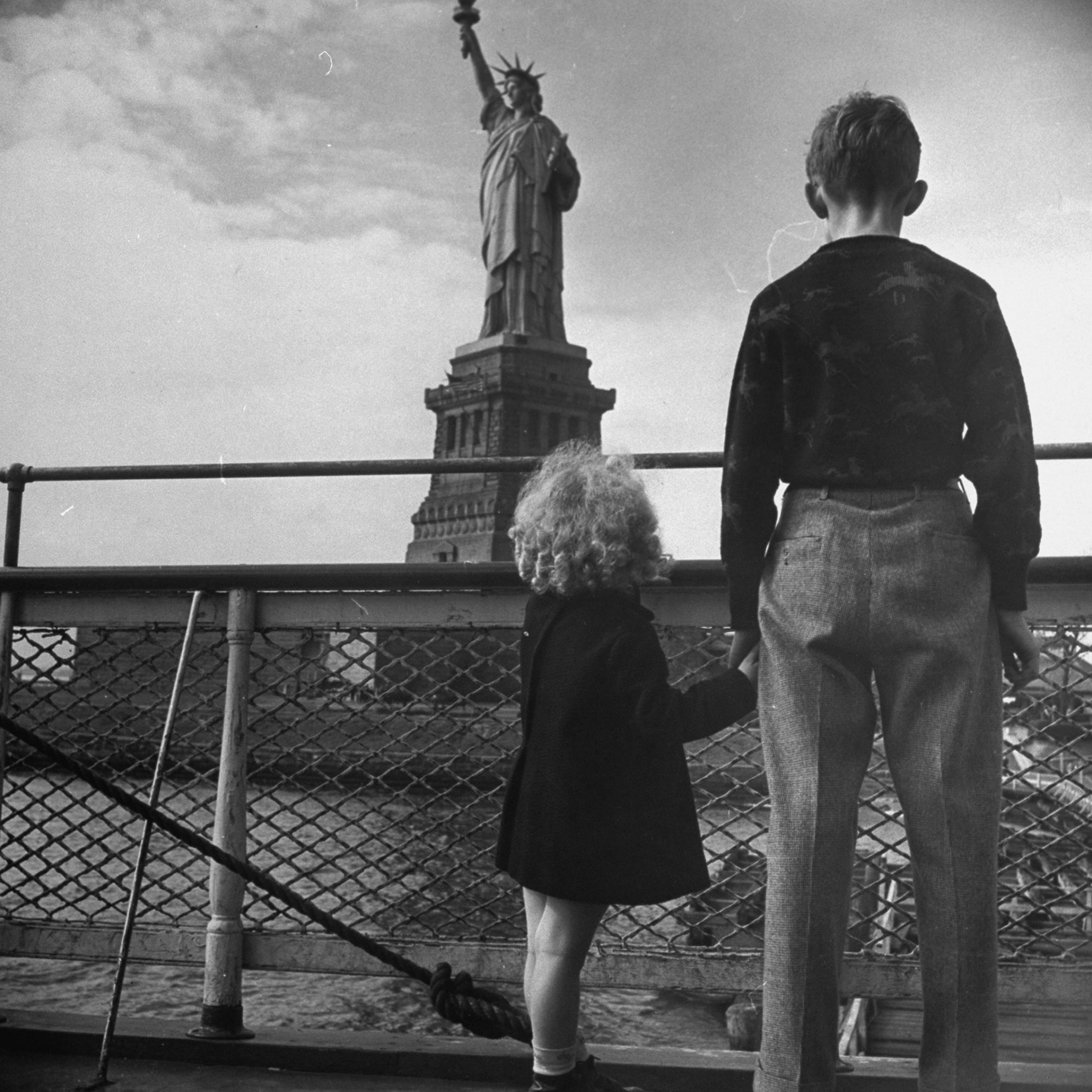 Refugee children gazing at Statue of Lib