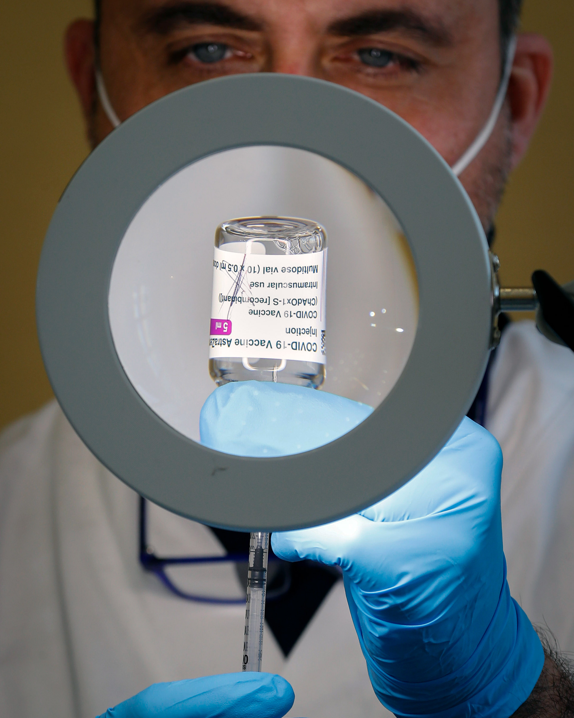A health worker prepares a dose of the AstraZeneca COVID-19