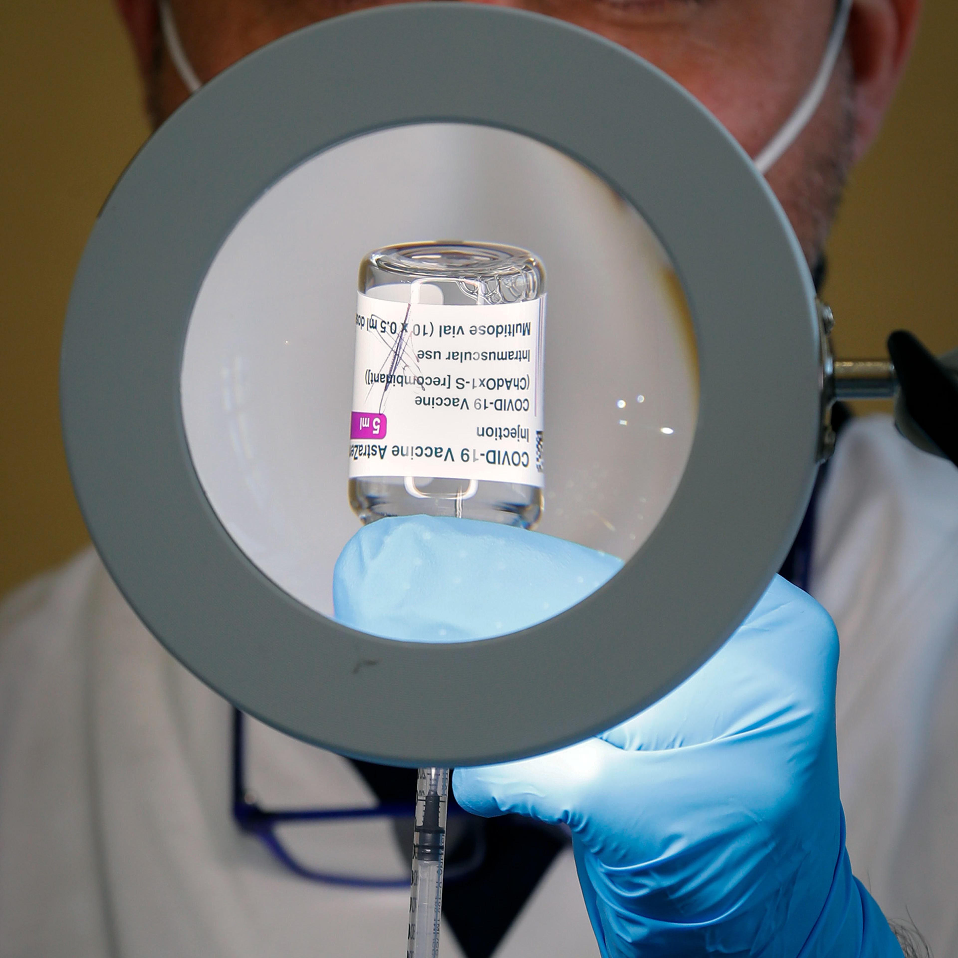 A health worker prepares a dose of the AstraZeneca COVID-19