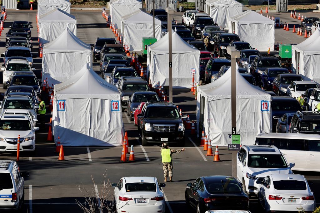 Members of the National Guard help drivers at a COVID-19 vaccination site on the campus of California State University of Los Angeles in Los Angeles County, California, the United States, Feb. 22, 2021