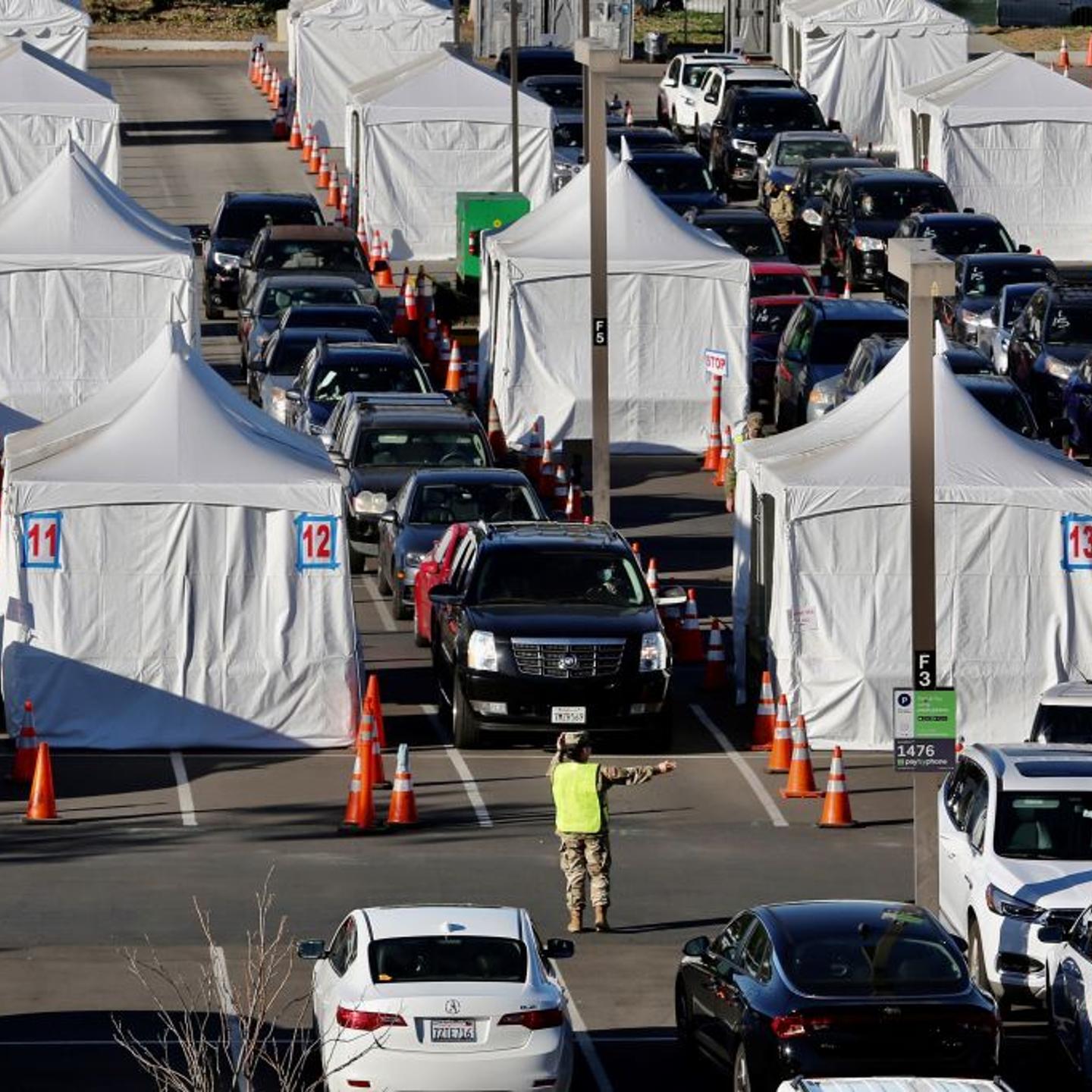 Members of the National Guard help drivers at a COVID-19 vaccination site on the campus of California State University of Los Angeles in Los Angeles County, California, the United States, Feb. 22, 2021