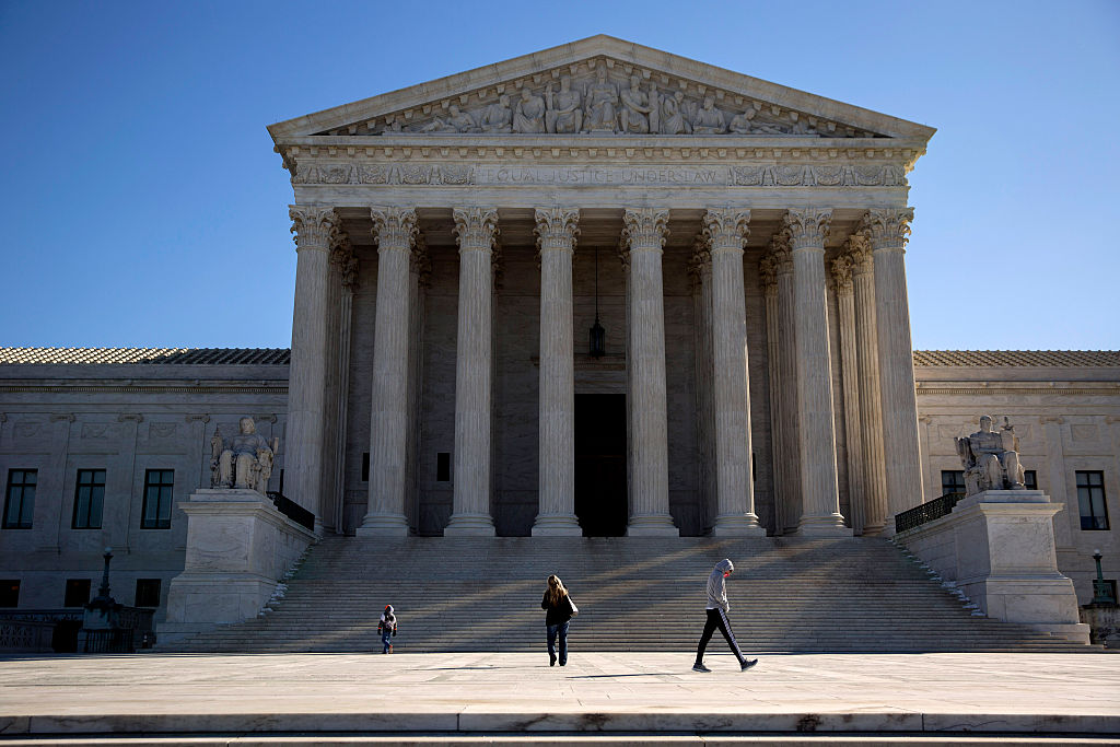 Visitors walk outside the U.S. Supreme Court following the death of Supreme Court Justice Antonin Scalia.