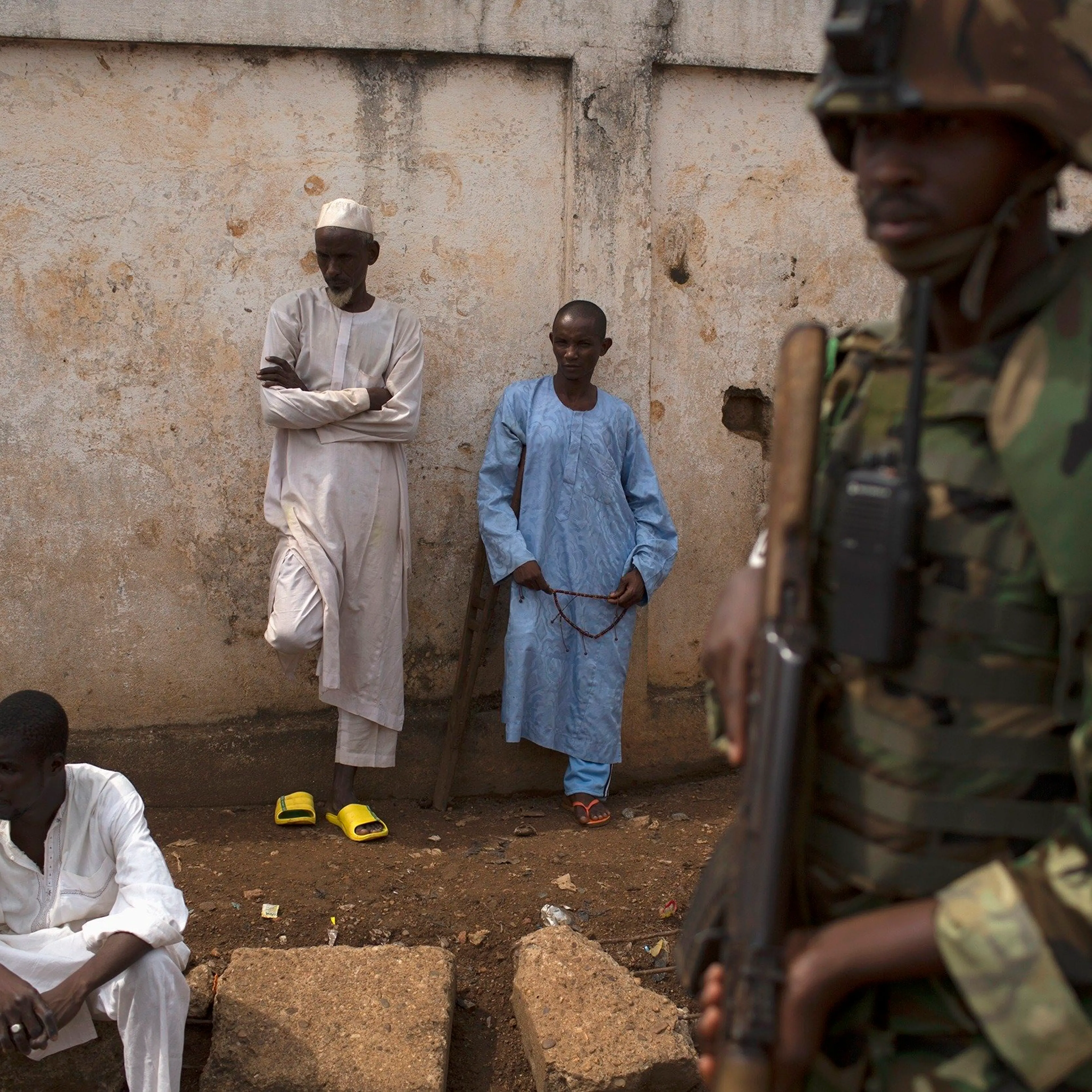 An African Union (AU) soldier stands guard outside a home at the end of a funeral of two men killed by sectarian violence in the Muslim neighbourhood of Kilometre 5 (PK5) in the capital Bangui
