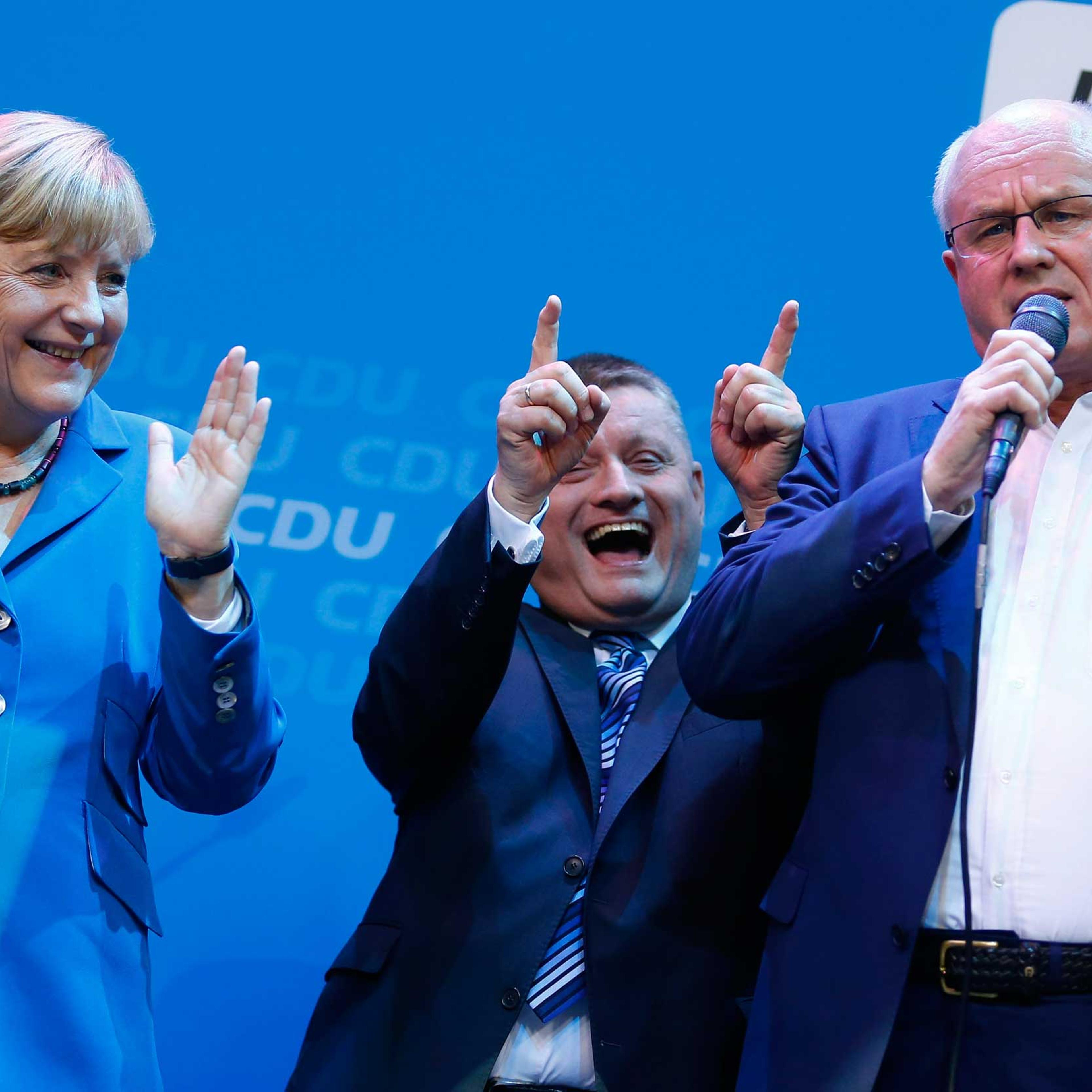 Leaders of the Christian Democratic Union sing with Chancellor Angela Merkel as they celebrate the exit polls in the German general election at the party headquarters in Berlin, Sept. 22, 2013.