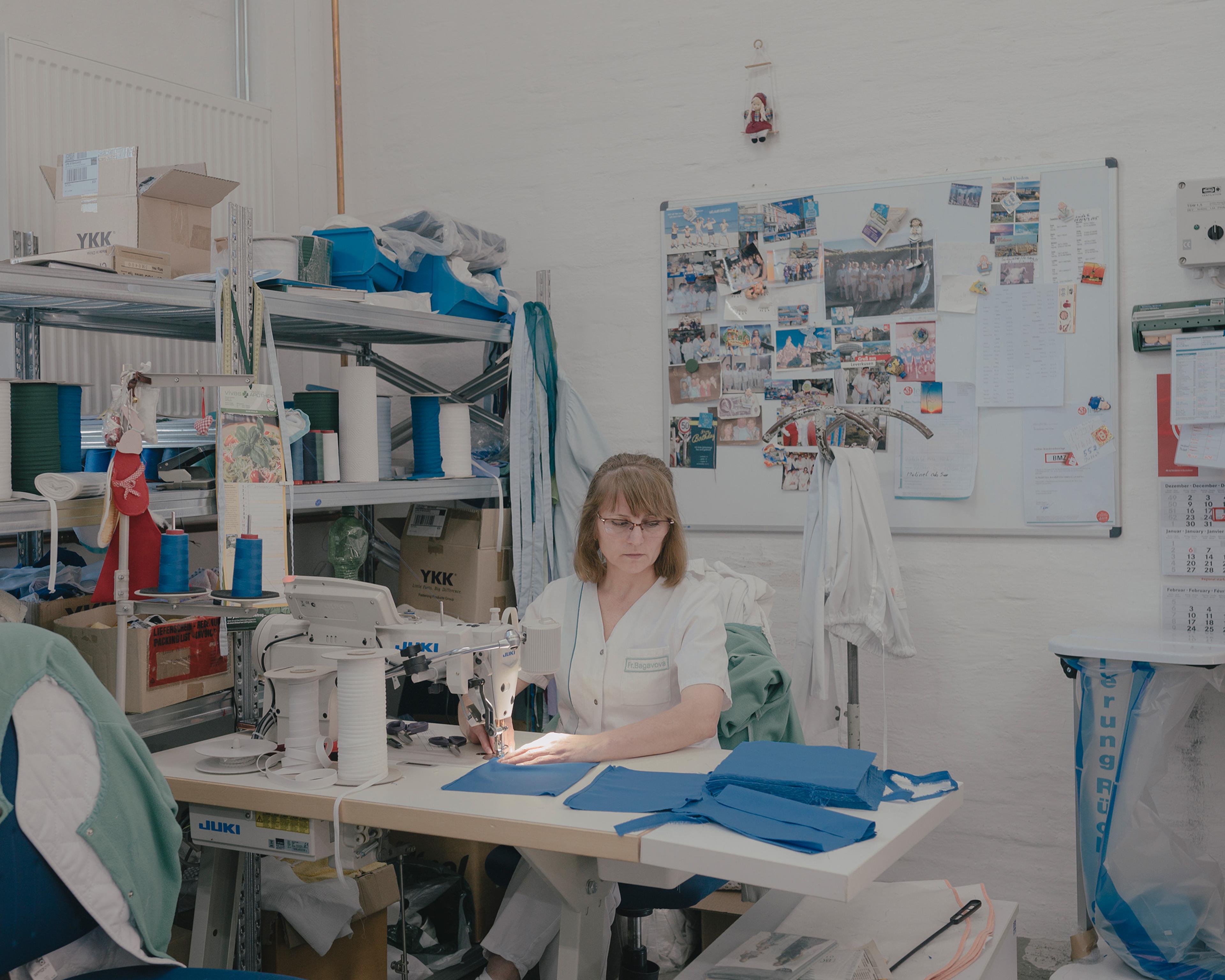 Minakhanym Bagavova sews reusable hybrid face masks in the sewing room at the textile services company Sitex in Minden on April 8.