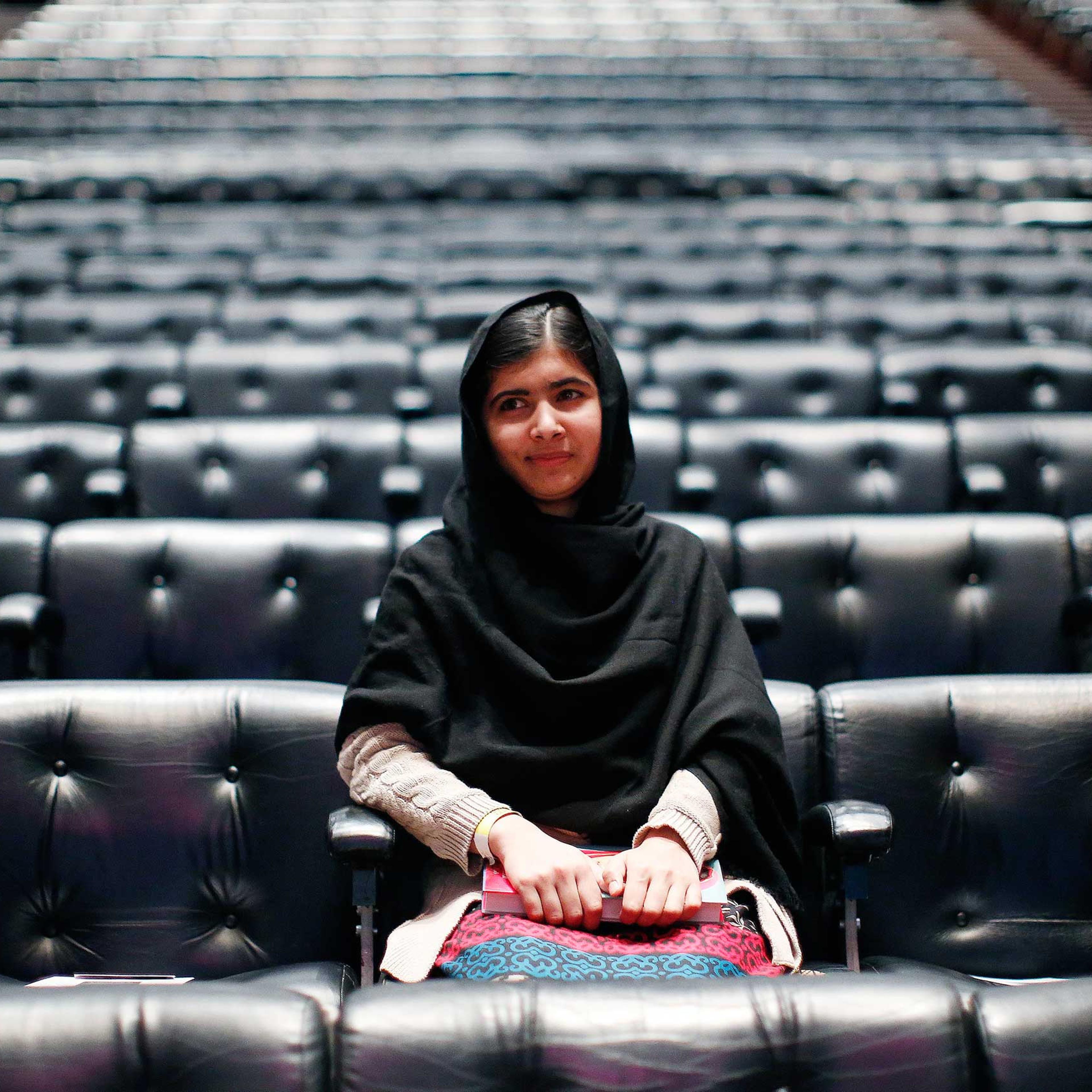 Pakistani teenage activist Yousafzai poses for pictures before an event launching her memoir "I Am Malala" in London