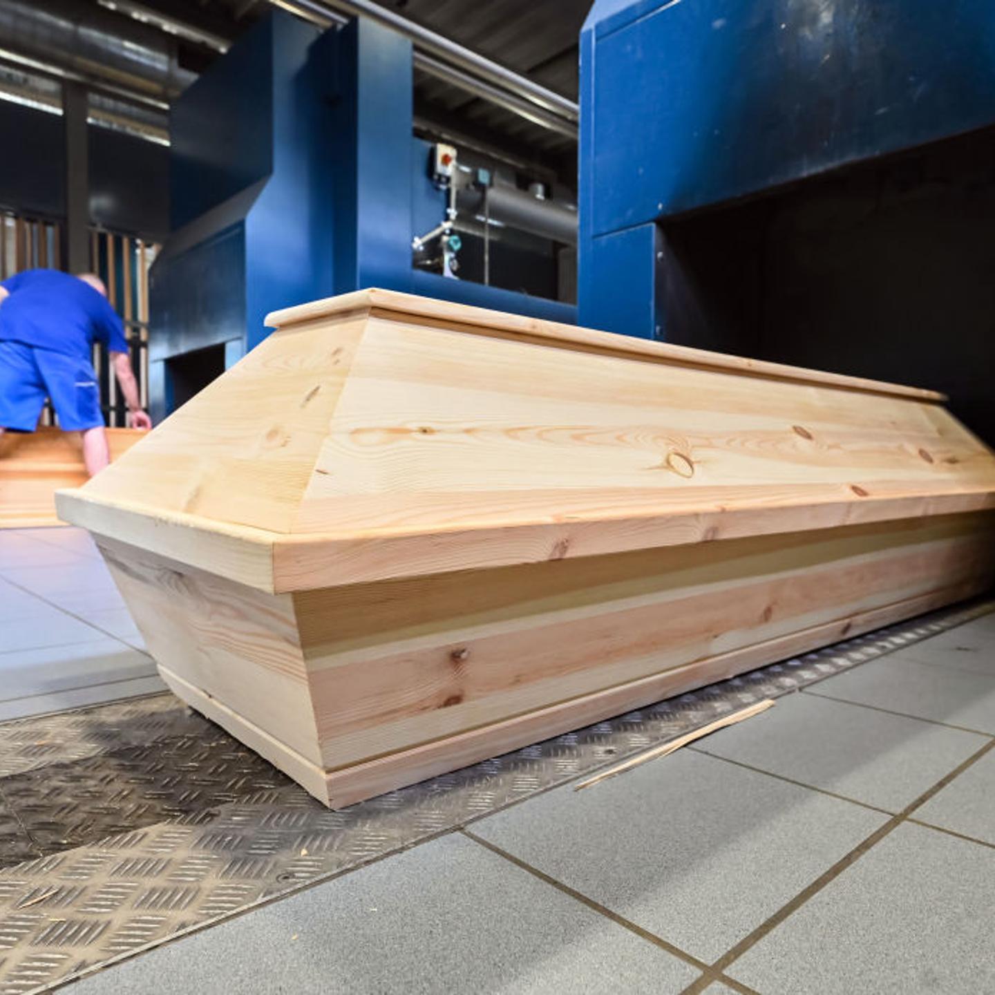 Coffins stand in front of cremation ovens at the crematorium in Karlsruhe's main cemetery in Baden-Württemberg, Germany on July 14, 2022.