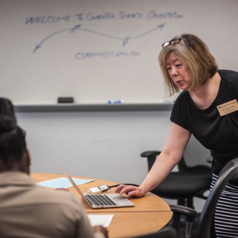 Professor Pearl Wang, Associate Chair of the Computer Science department at George Mason University, speaks with Khadija Allotey, 22, a transfer student from Strayer University, during an orientation session.
