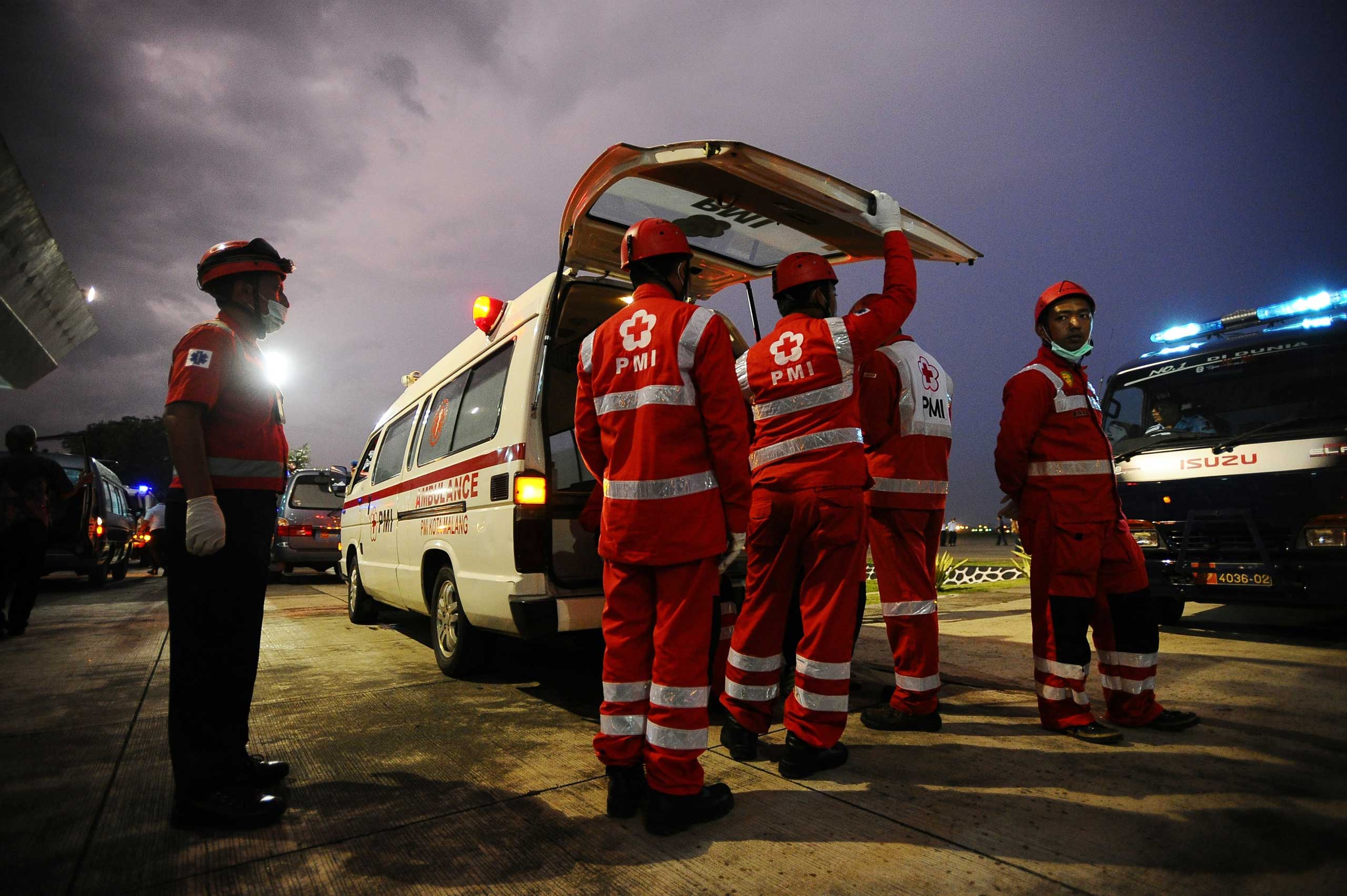 Indonesian Red Cross members prepare to move coffins containing victims of the AirAsia flight QZ8501 crash for identification on Jan. 2 in Surabaya, Indonesia.