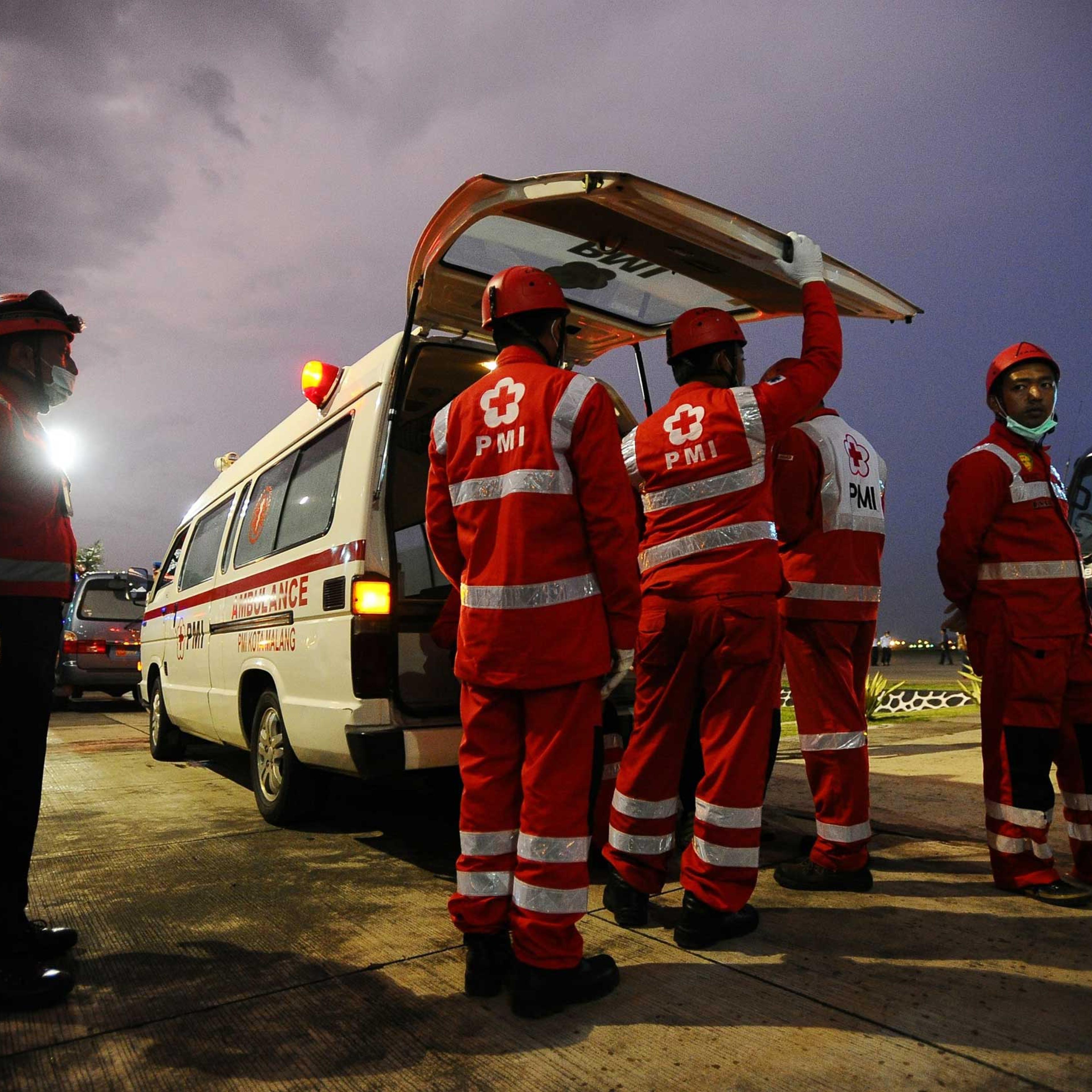 Indonesian Red Cross members prepare to move coffins containing victims of the AirAsia flight QZ8501 crash for identification on Jan. 2 in Surabaya, Indonesia.