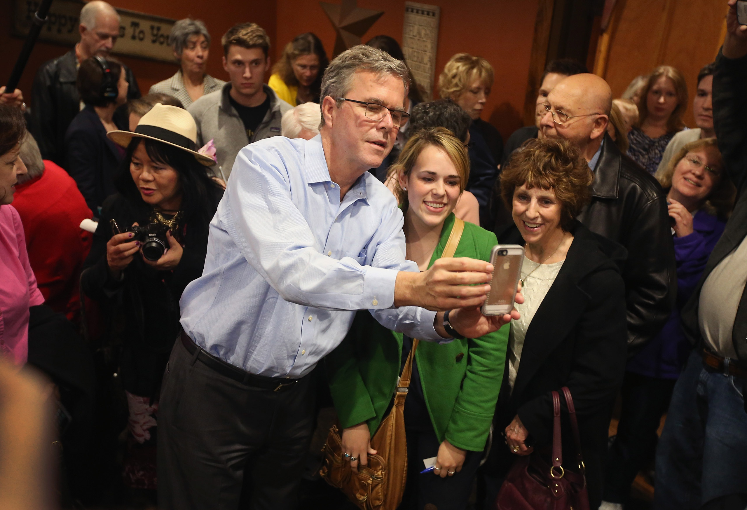 CEDAR RAPIDS, IA - MARCH 07: Former Florida Governor Jeb Bush takes a selfie with Iowa residents after speaking at a Pizza Ranch restaurant on March 7, 2015 in Cedar Rapids, Iowa. Earlier in the day Bush spoke at the Iowa Ag summit in Des Moines. The Ag 