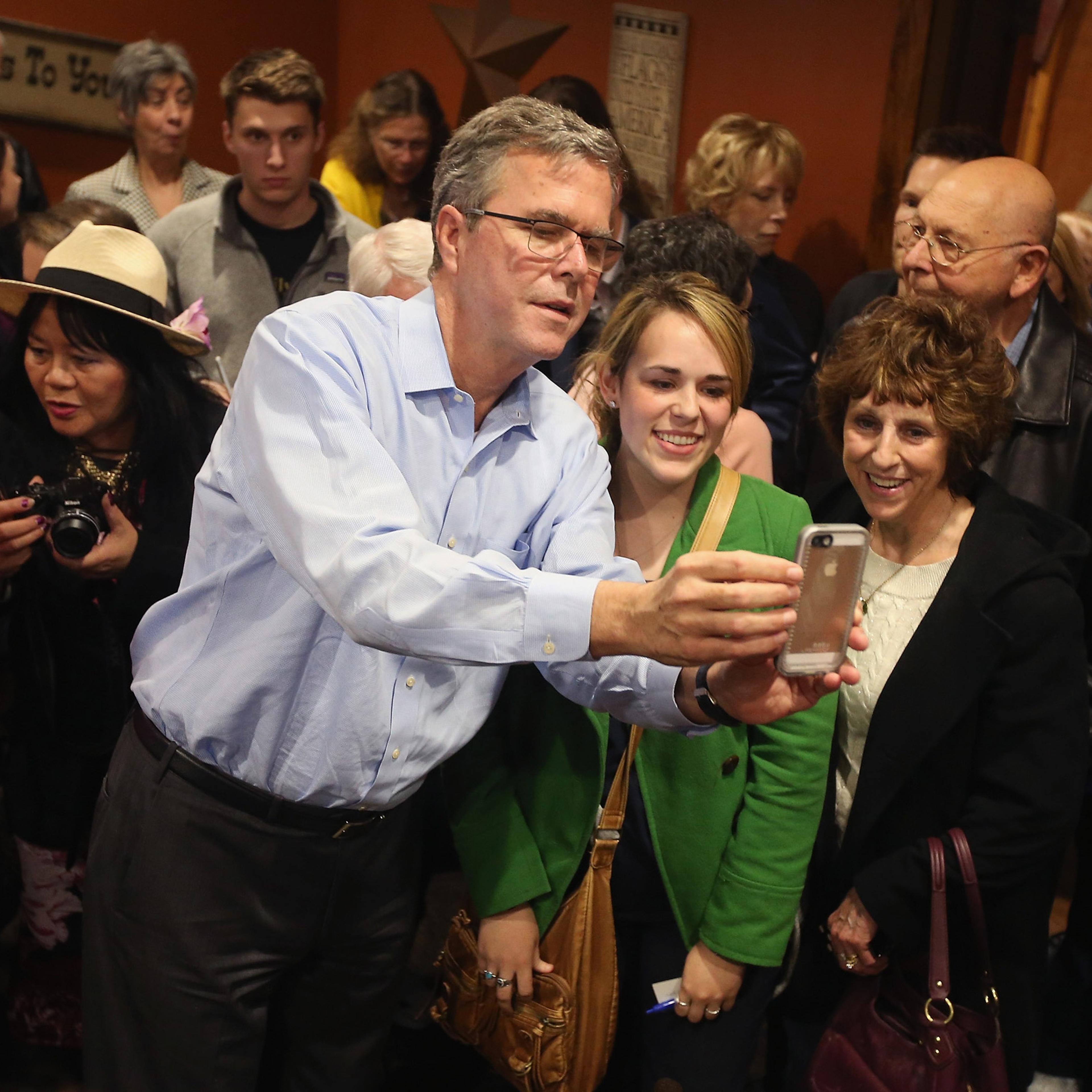 CEDAR RAPIDS, IA - MARCH 07: Former Florida Governor Jeb Bush takes a selfie with Iowa residents after speaking at a Pizza Ranch restaurant on March 7, 2015 in Cedar Rapids, Iowa. Earlier in the day Bush spoke at the Iowa Ag summit in Des Moines. The Ag