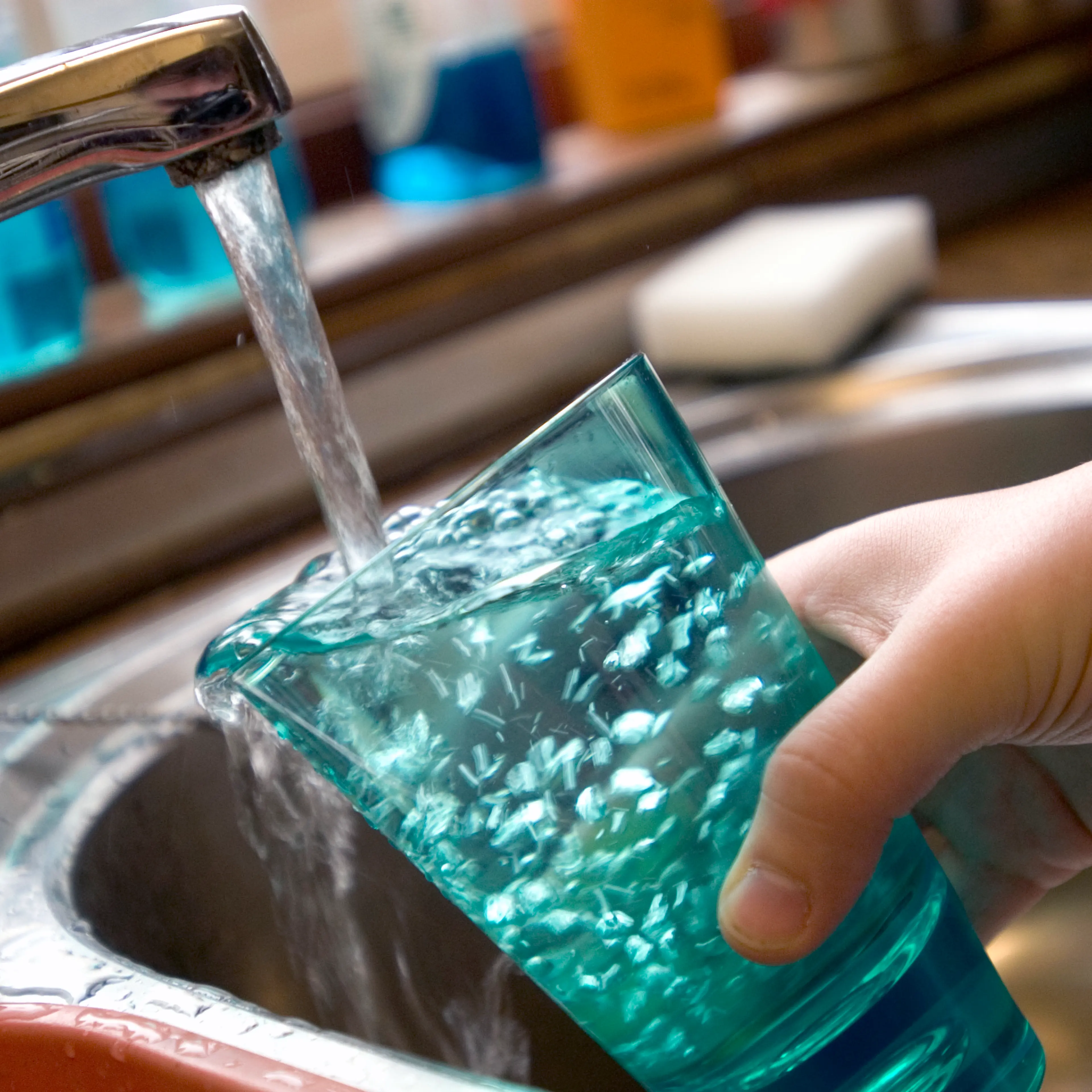 Child filling glass with tap water UK