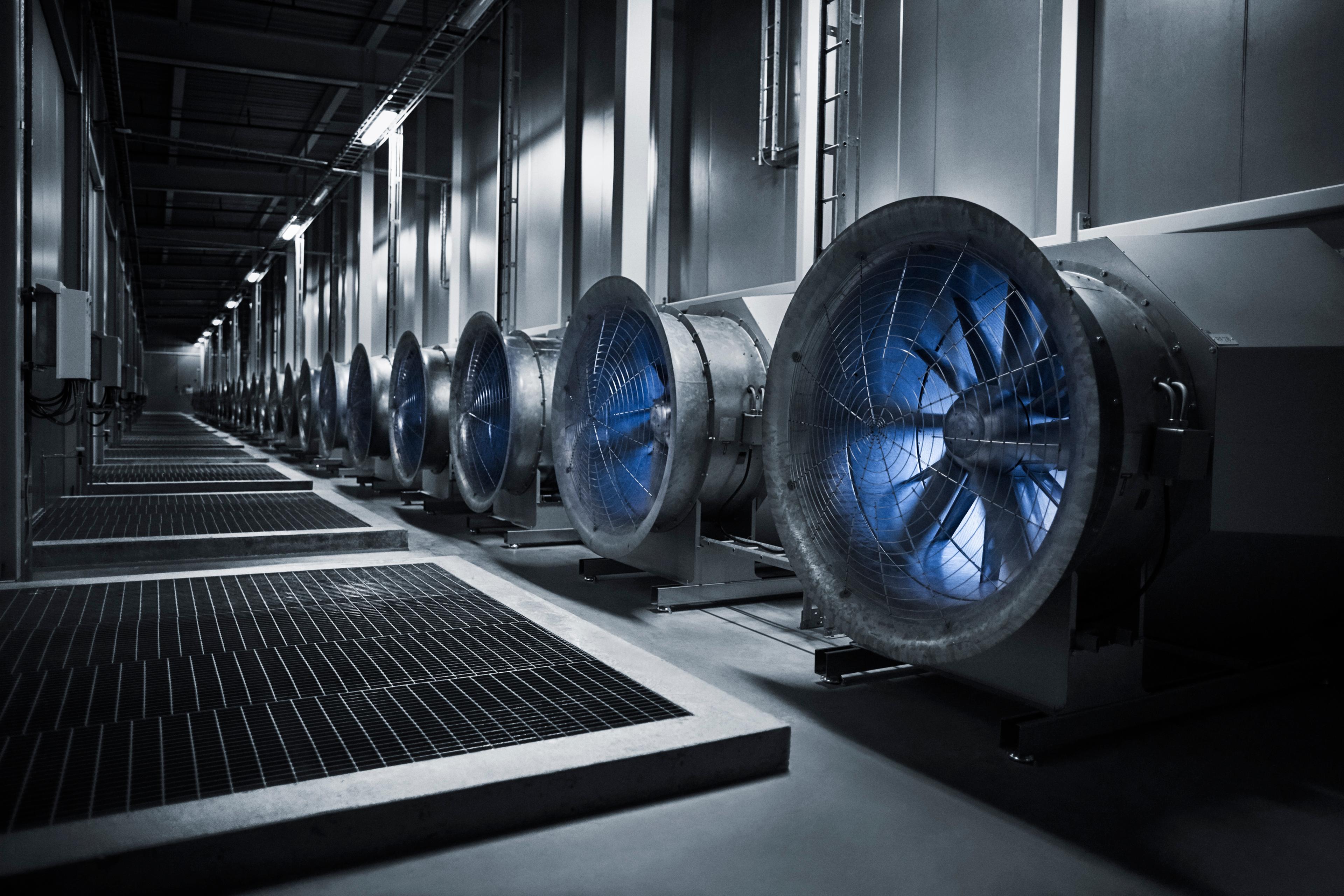 These enormous fans draw in the outside air to cool the servers in the data hall. In the winter, when temperatures plunge to -30 degrees the situation is reversed, and the heat from the servers warm the massive buildings.