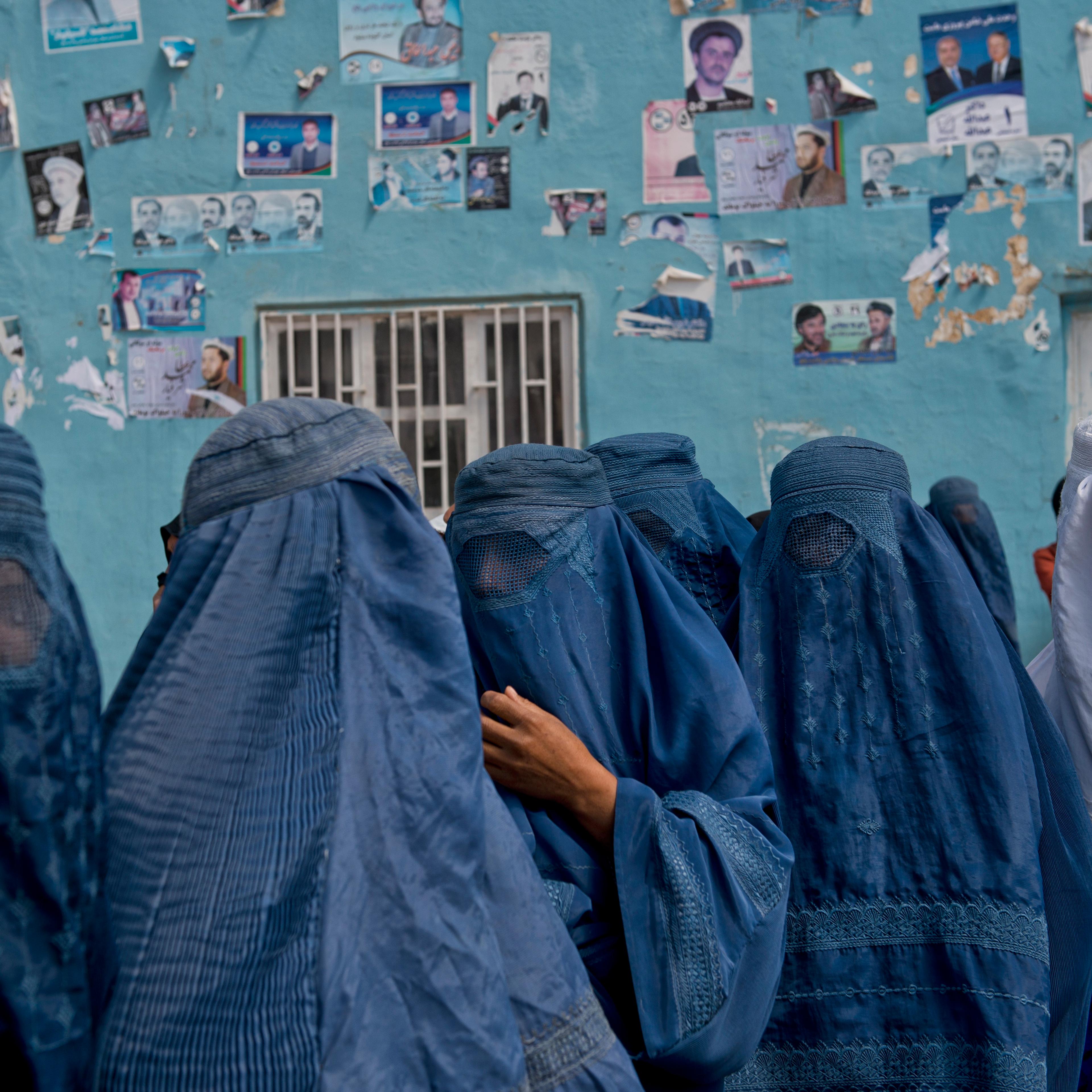 Afghan women leave a rally for Presidential candidate Dr. Zalmay Rassoul and Vice Presidential candidate Habiba Sourabi, in a stadium in Mazar-e-Sharif, Afghanistan