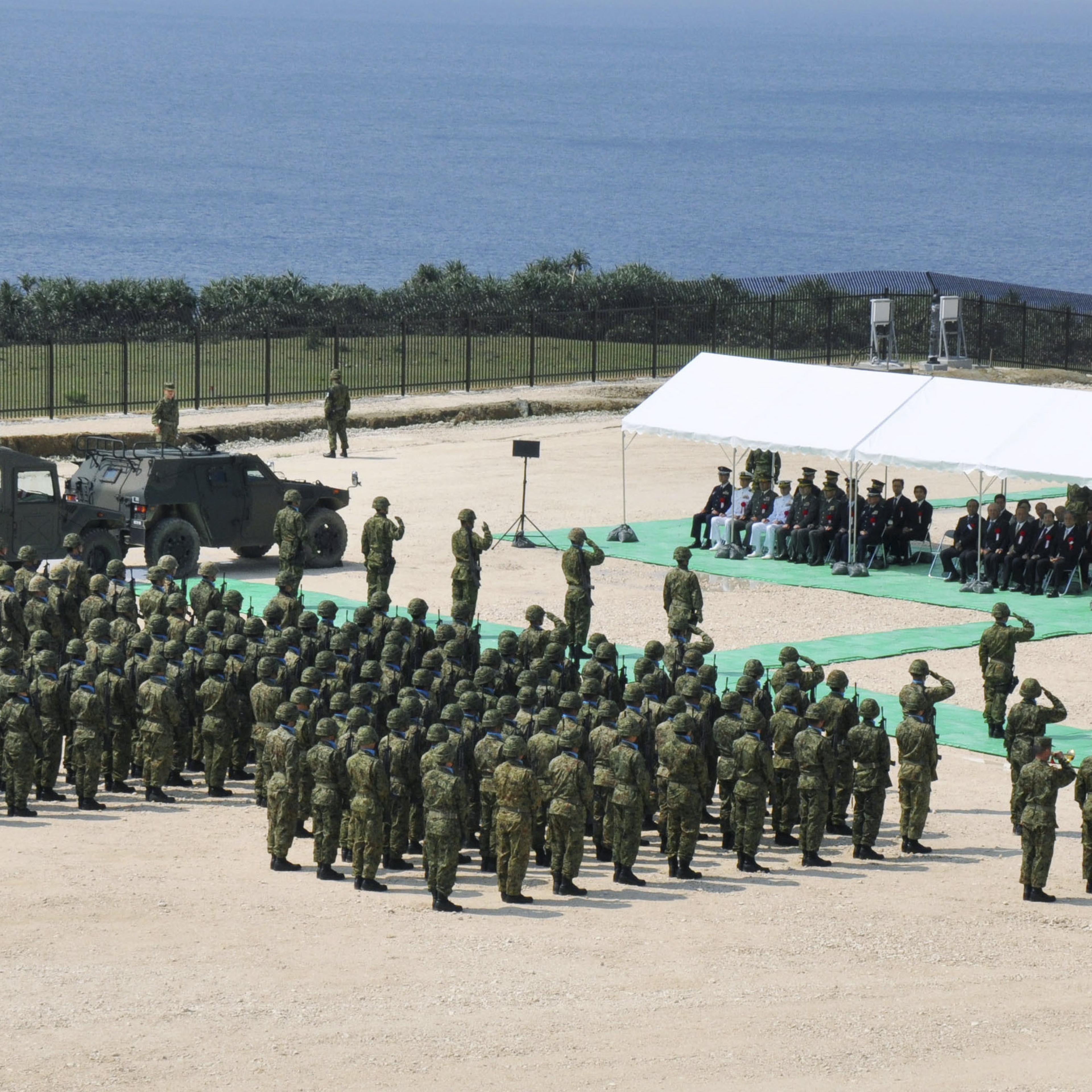 Members of Japan's Self Defence Force hold an opening ceremony of a new military base on the island of Yonaguni