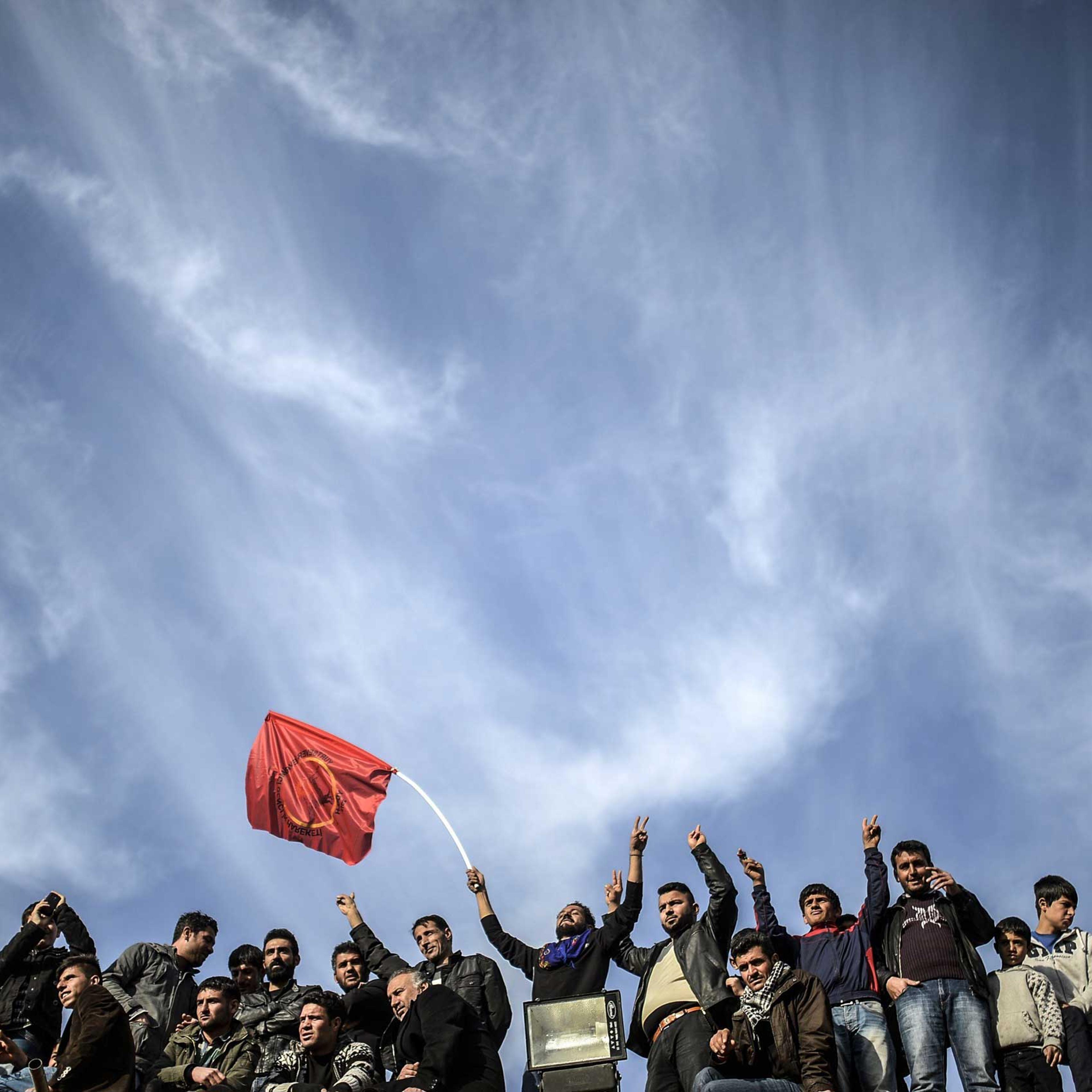 Kurdish people celebrate near the Turkish-Syrian border in Suruc, in Sanliurfa province in Turkey on Jan. 27, 2015.