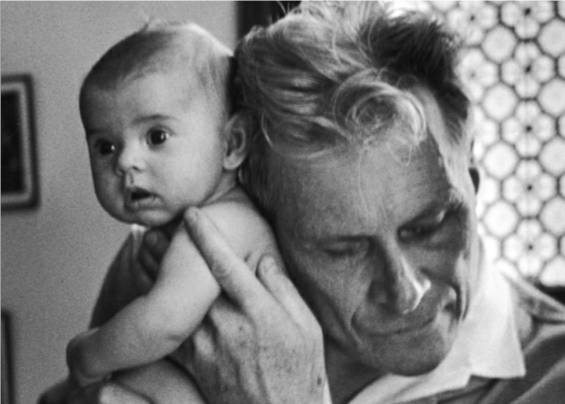Blind doctor Albert-Andre Nast holds his ear to the back of a 3-month old instead of using a stethoscope, France, 1953.