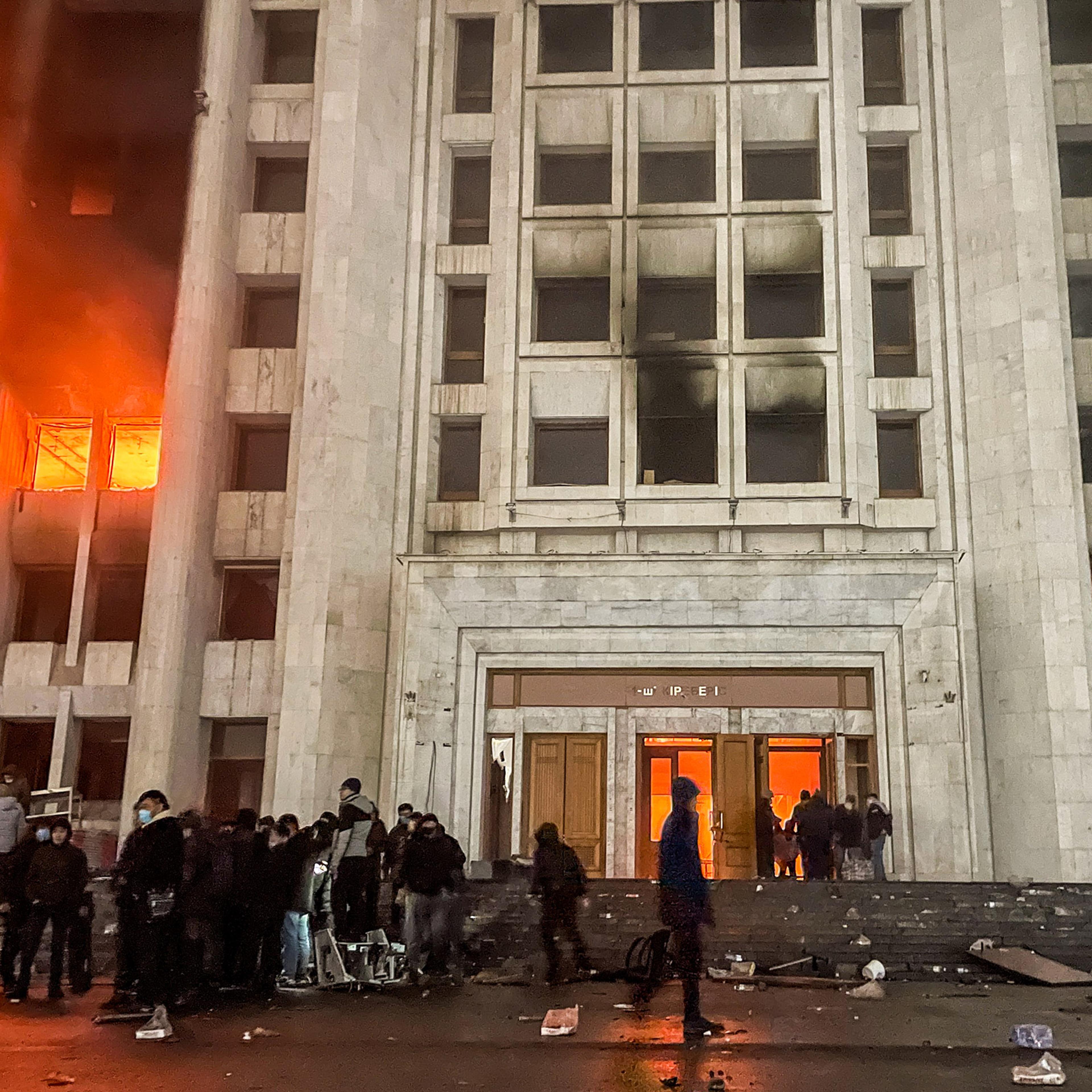 People protest outside the mayor's office in Almaty, Kazakhstan on Jan. 5, 2022. Protestors broke into the mayor's office and set it on fire.