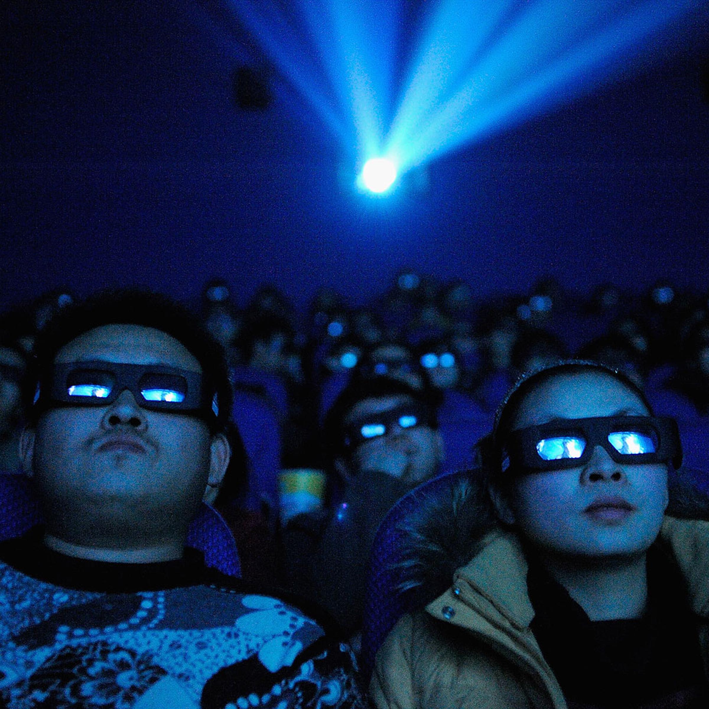 A Chinese cinema audience watches a movie through 3D glasses
