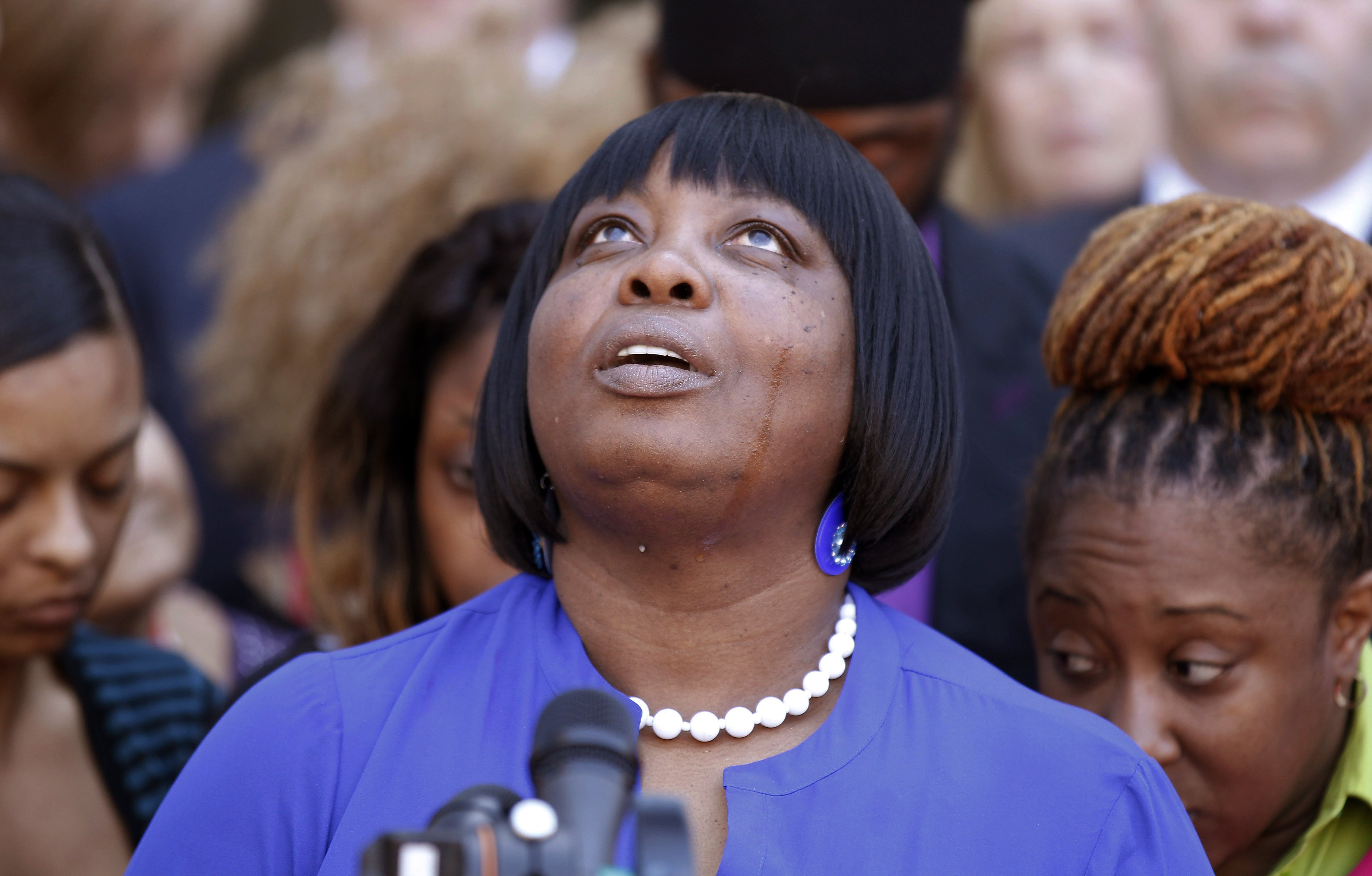Ursula Ward, mother of shooting victim Odin Lloyd, looks up to the heavens as she talks about her deceased son outside Bristol County Superior Court on April 15, 2015, in Fall River, Mass., after former New England Patriots football player Aaron Hernande