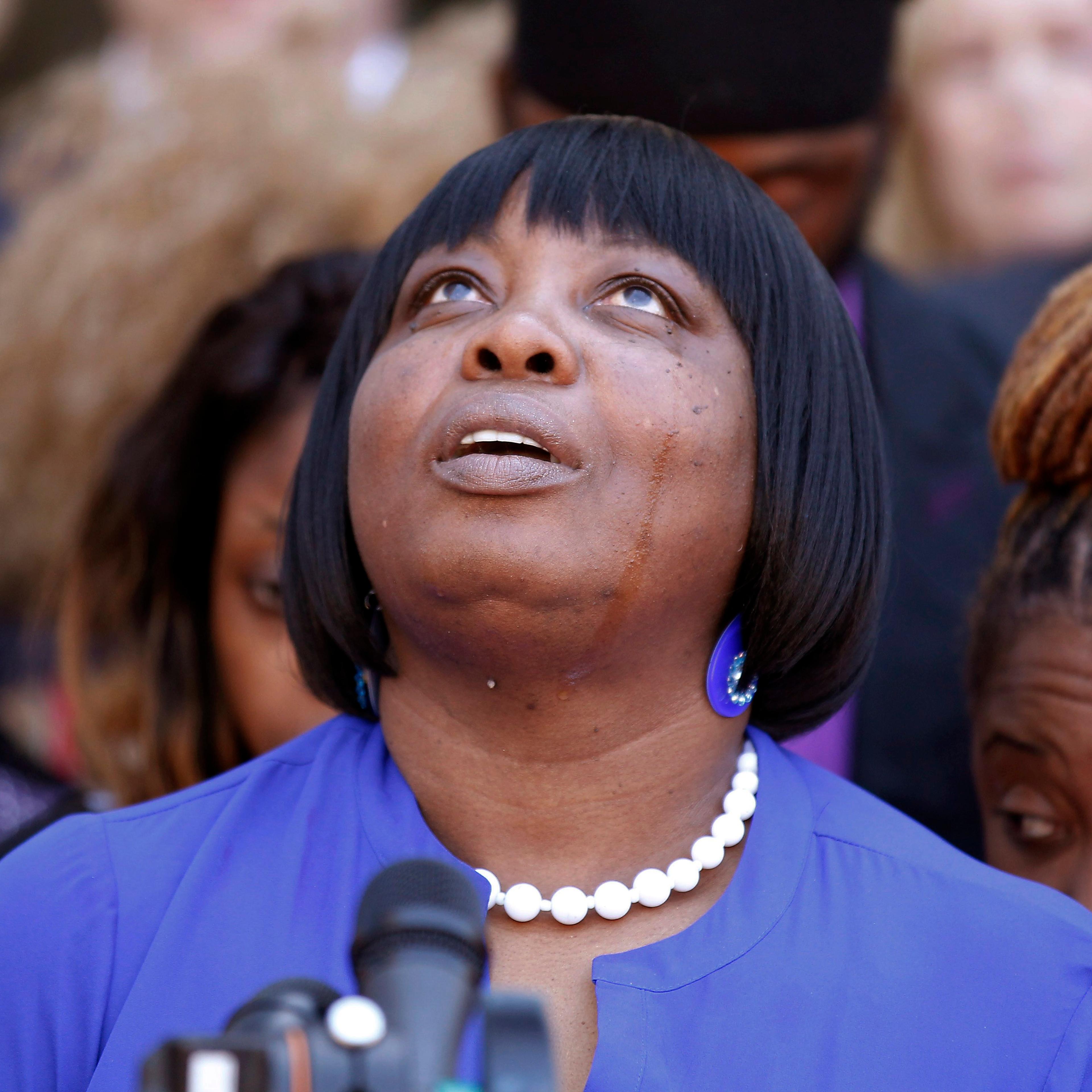 Ursula Ward, mother of shooting victim Odin Lloyd, looks up to the heavens as she talks about her deceased son outside Bristol County Superior Court on April 15, 2015, in Fall River, Mass., after former New England Patriots football player Aaron Hernande