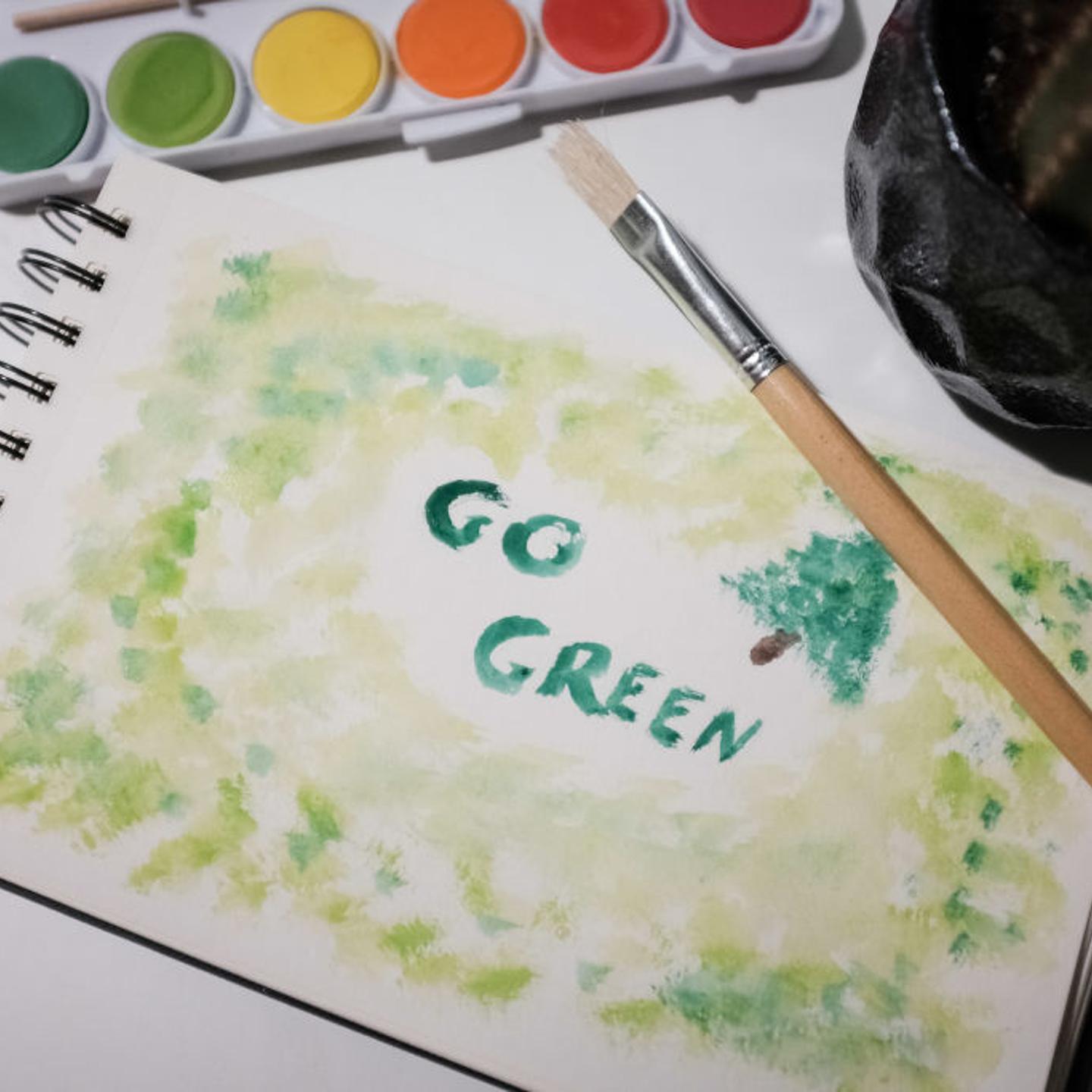'Go Green' is painted on a drawing book in Athens, Greece on March 20, 2023.
