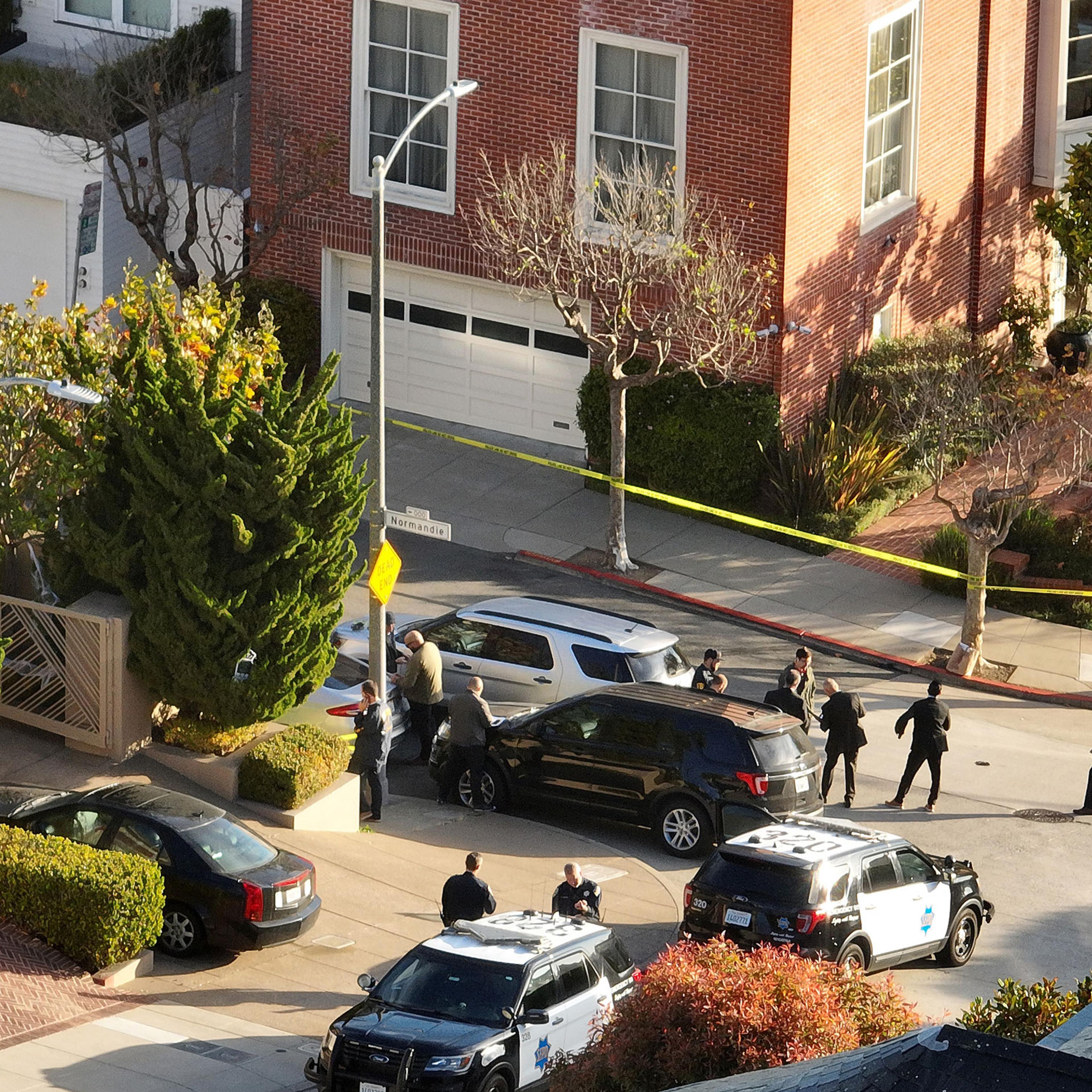 San Francisco police officers and F.B.I. agents gather in front of the home of U.S. Speaker of the House Nancy Pelosi