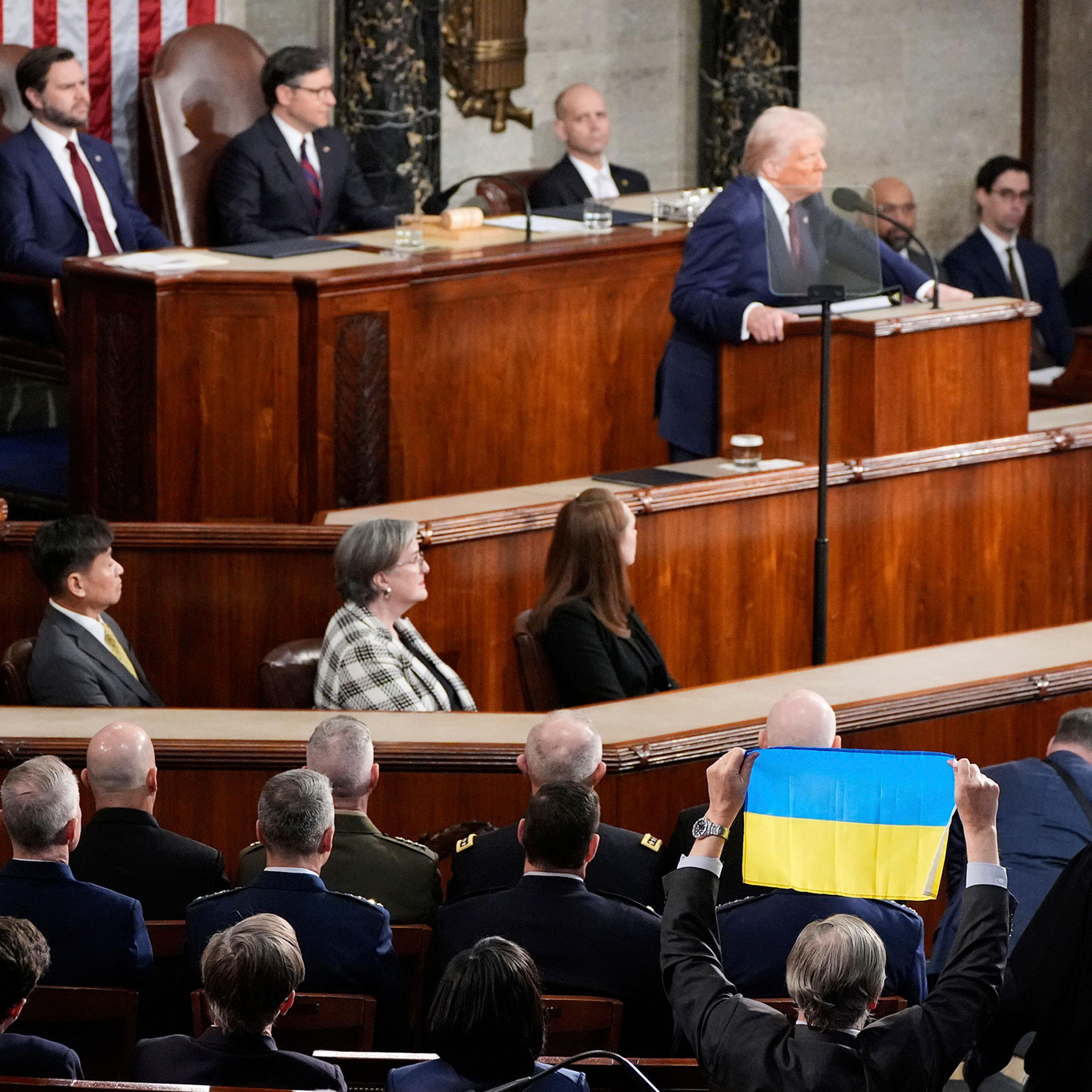 A member of Congress holds up Ukraine's flag as President Donald Trump addresses a joint session of Congress at the Capitol in Washington, on March 4, 2025.