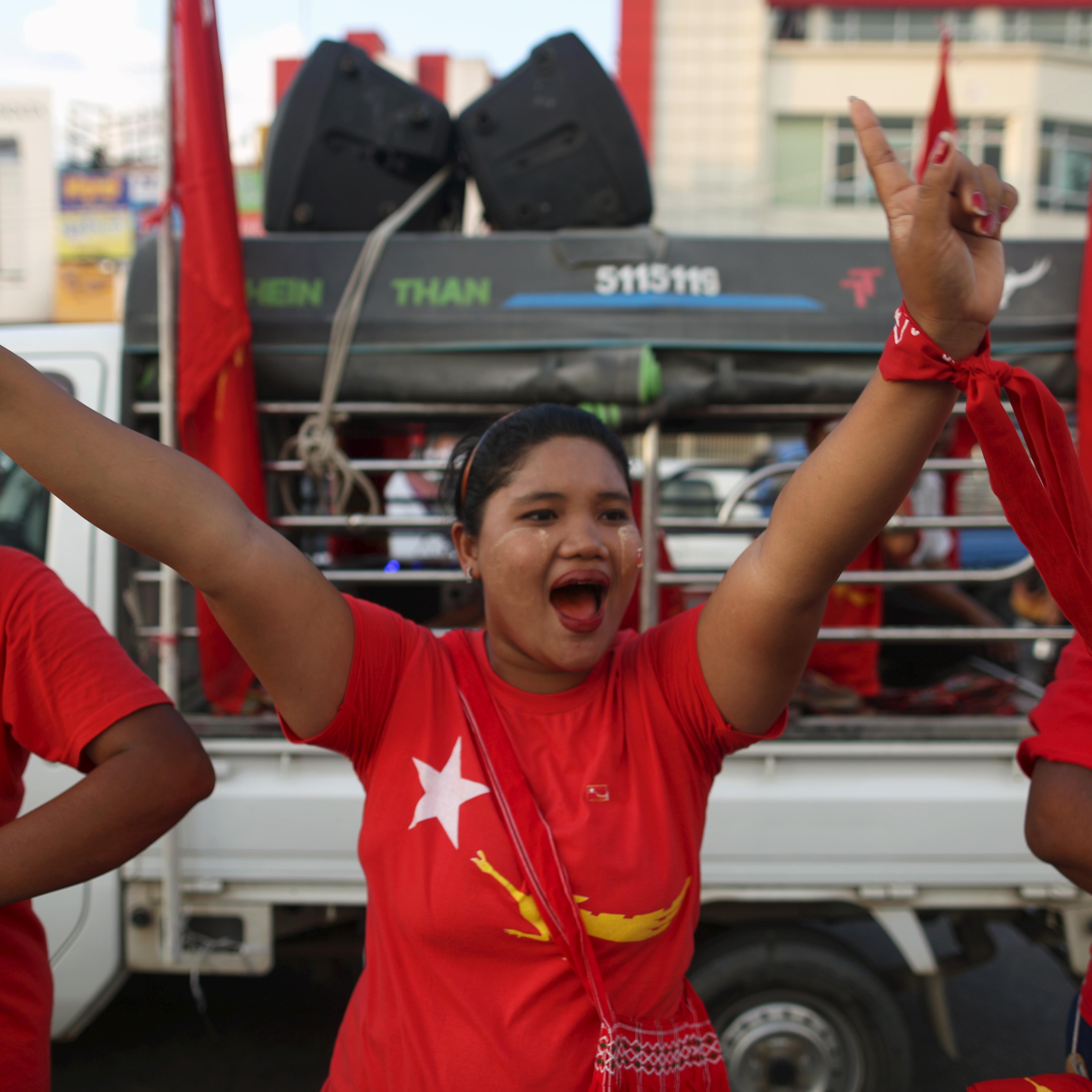 Supporters dance during a NLD party campaign rally in Yangon