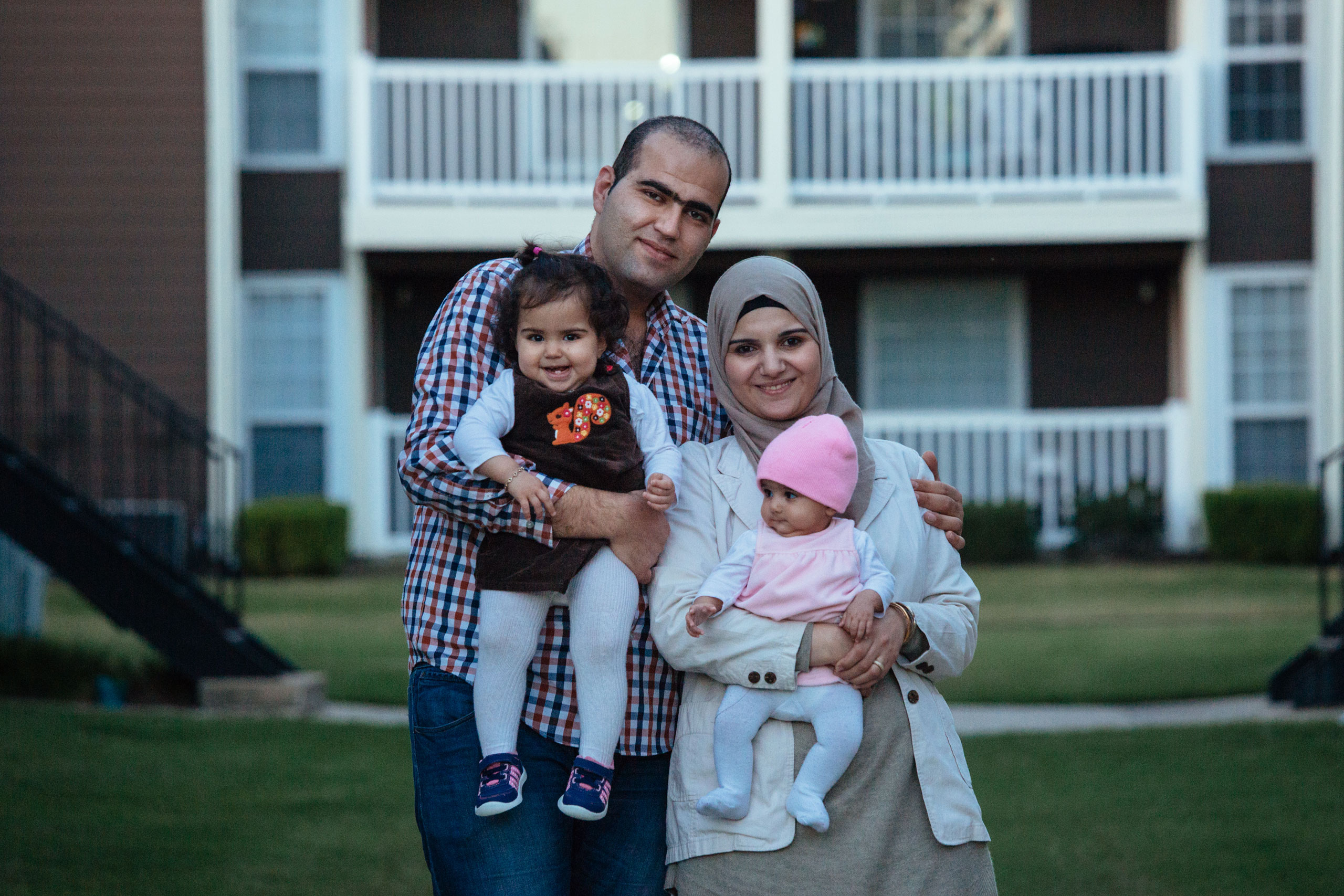 A portrait of the al Sharaa family (Faez, 28, Shaza, 28, Sham, 14 months, Sara, 4 months) at their apartment complex in Richardson, Texas on Nov. 19, 2015.