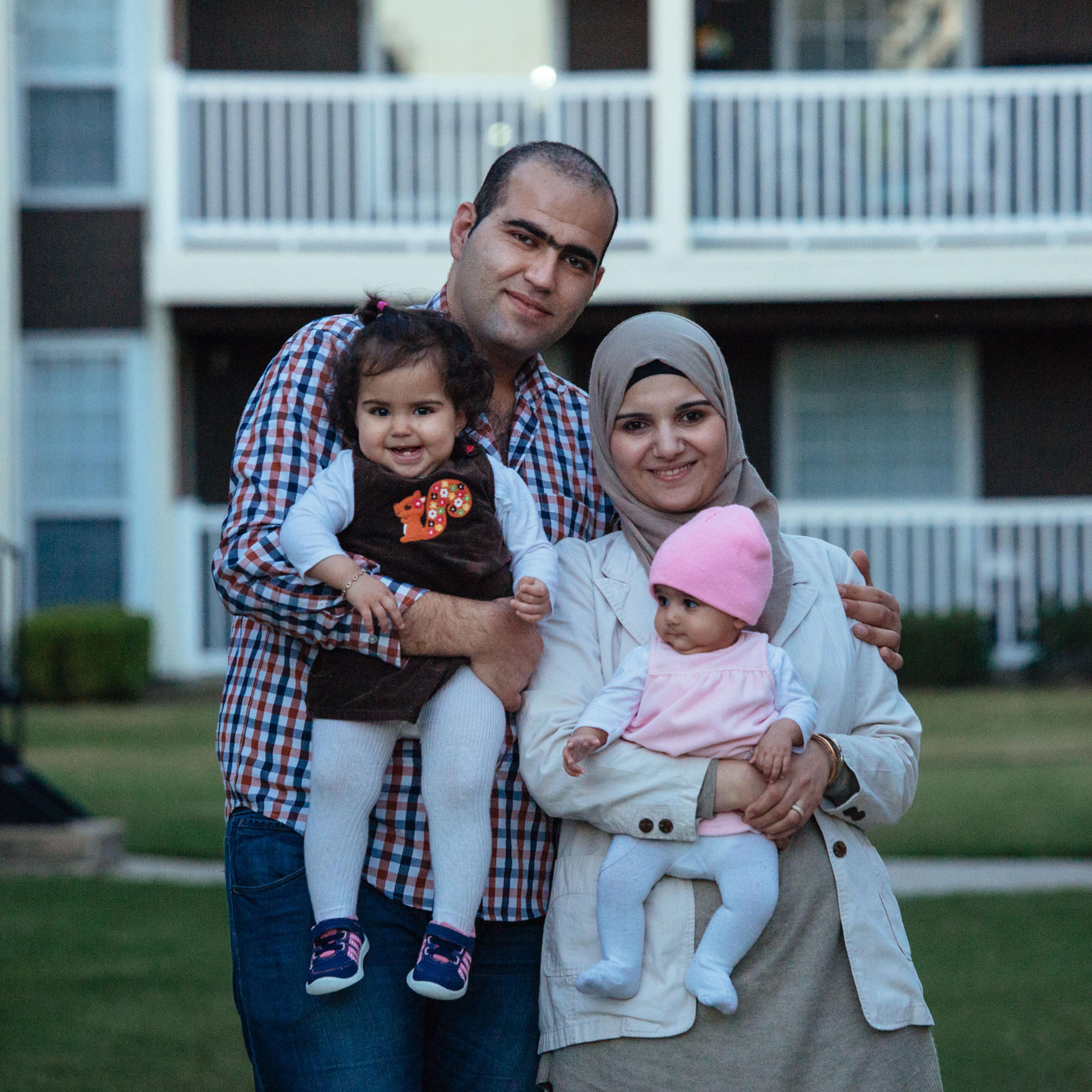 A portrait of the al Sharaa family (Faez, 28, Shaza, 28, Sham, 14 months, Sara, 4 months) at their apartment complex in Richardson, Texas on Nov. 19, 2015.