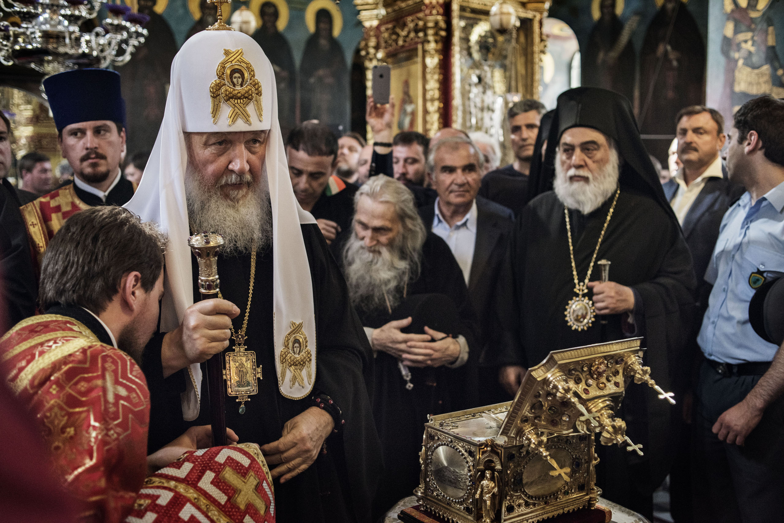 Patriarch Kirill of the Russian Orthodox Church stands before the reliquary, a bejeweled box containing a holy relic, at the main church in St. Panteleimon, the Russian monastery on Mount Athos, in northern Greece, May 27, 2016. Behind him bows the abbot
