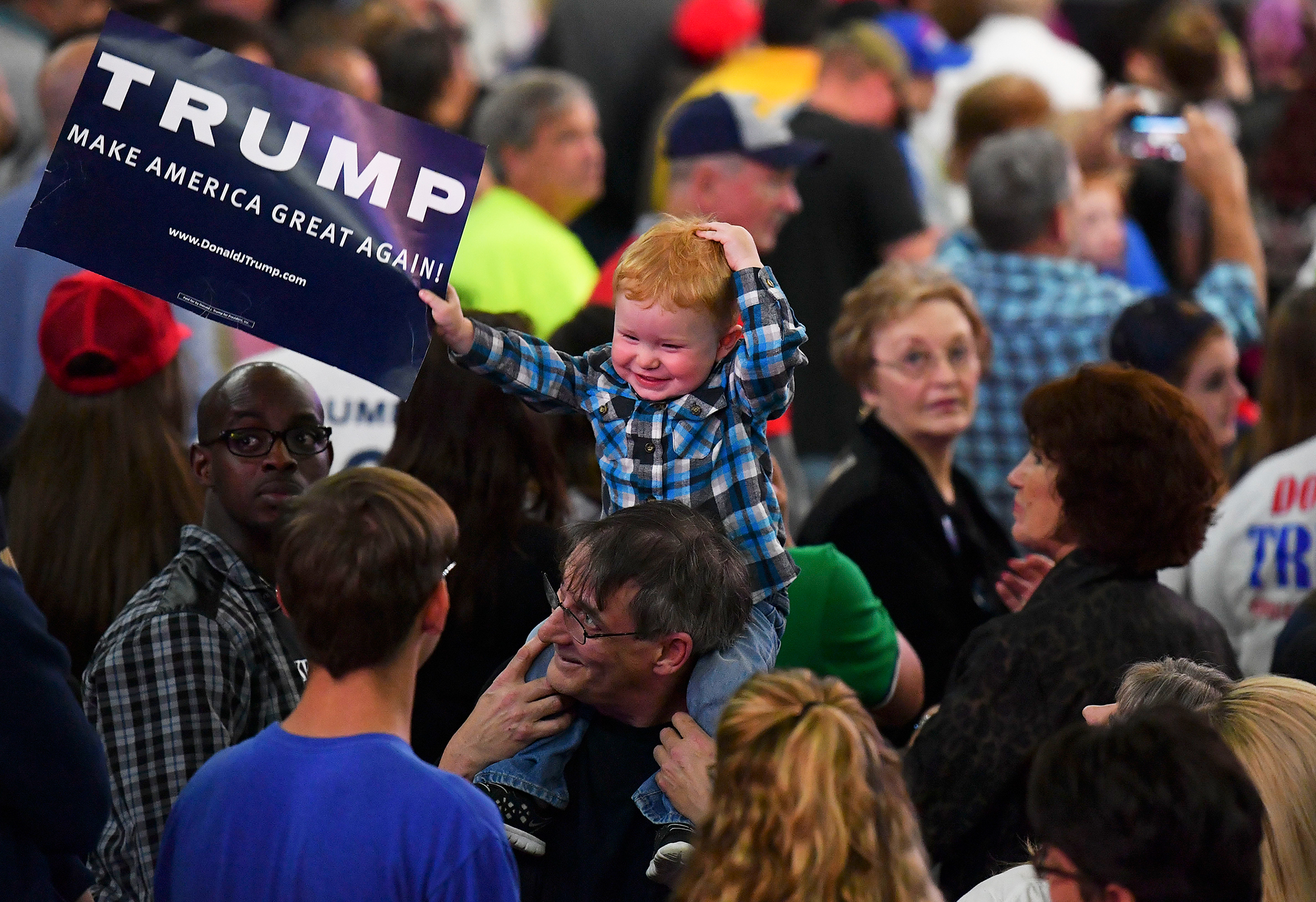 A child waves a Trump sign before Republican presidential candidate Donald Trump addresses his supporters during a rally at on May 5, 2016 in Charleston, W.V.