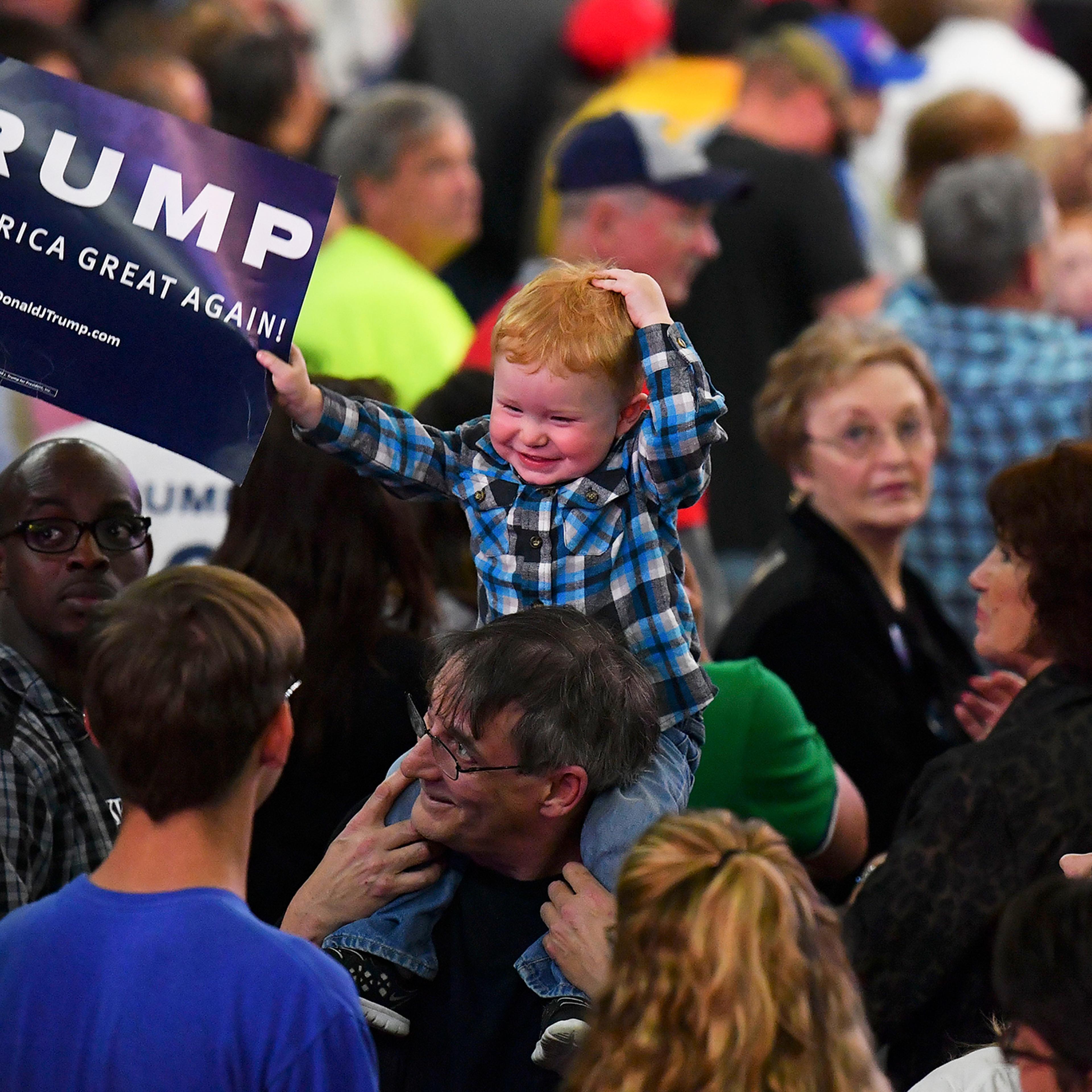 A child waves a Trump sign before Republican presidential candidate Donald Trump addresses his supporters during a rally at on May 5, 2016 in Charleston, W.V.