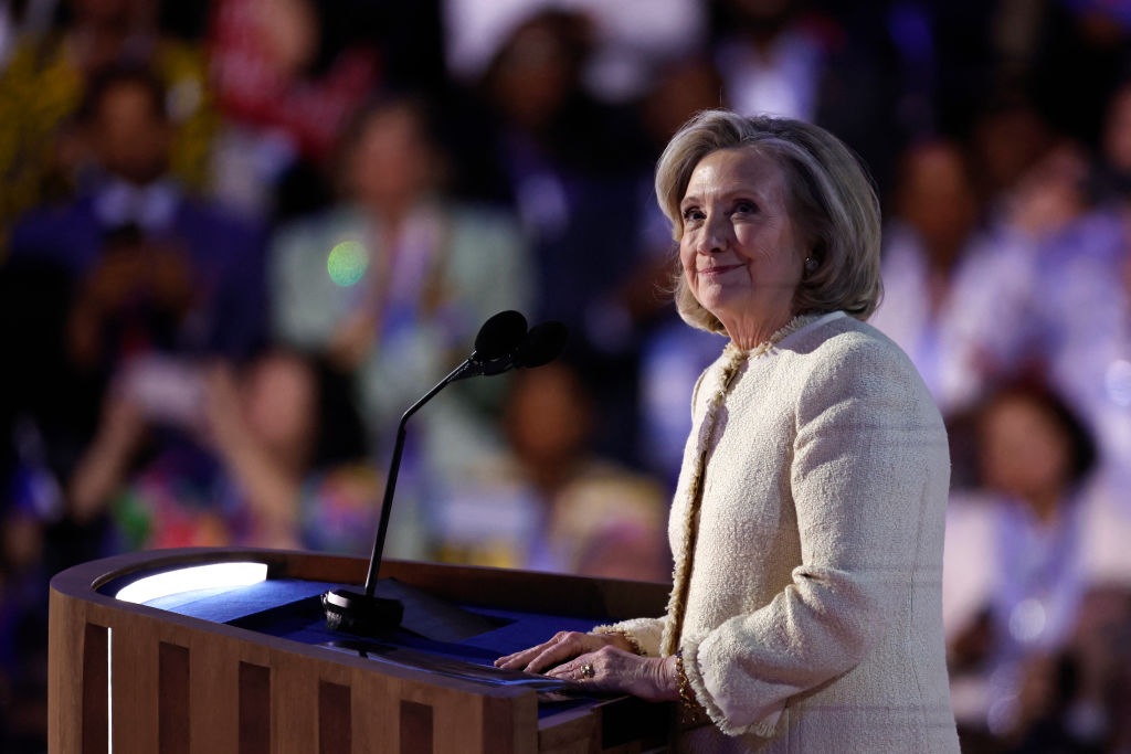 Former U.S. Secretary of State Hillary Clinton looks on as she is applauded after arriving on stage to speak on the first day of the Democratic National Convention (DNC) at the United Center in Chicago, Illinois, on August 19, 2024.