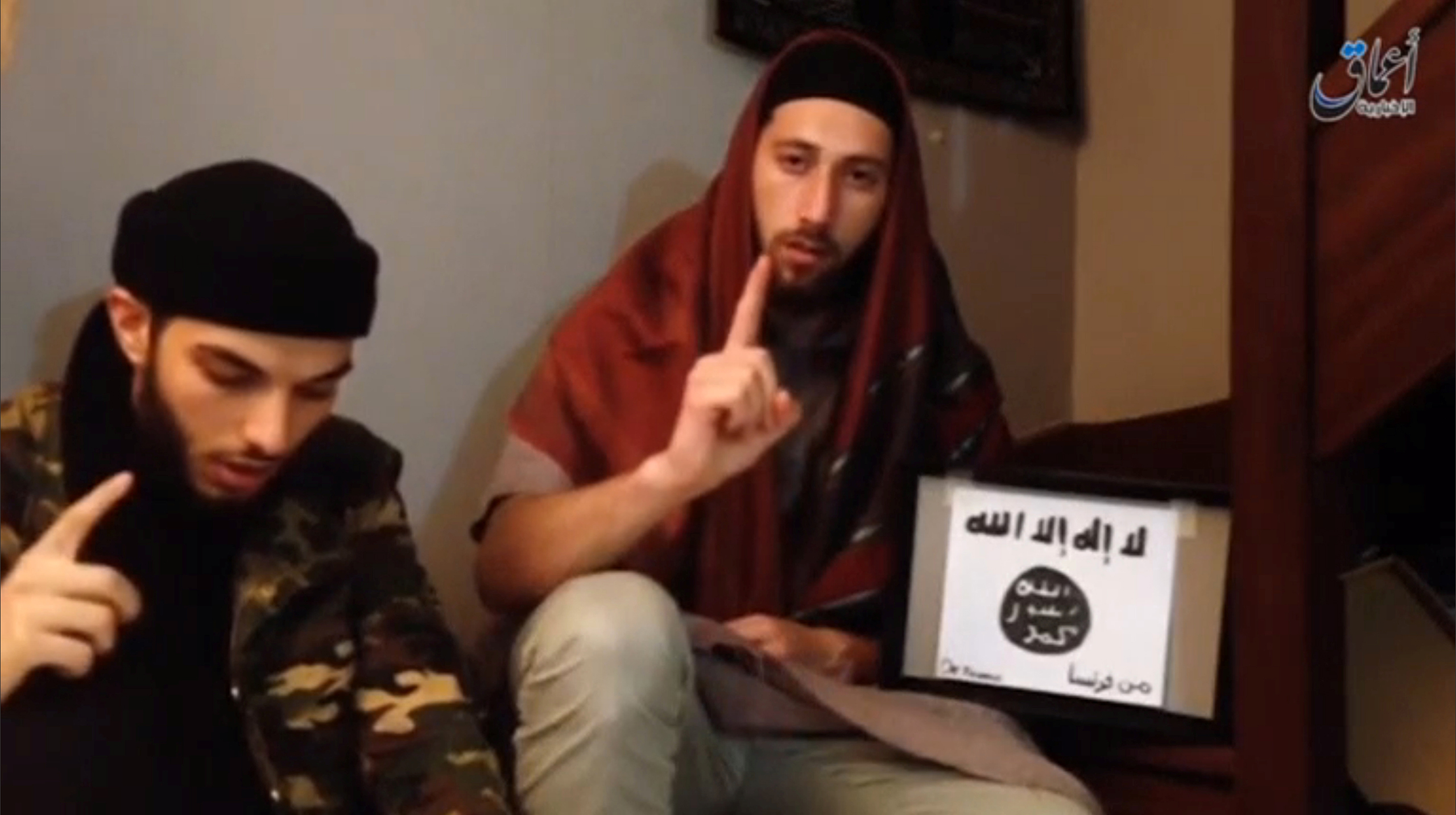 A still image taken from an undated video posted on social media shows two men that the Islamic State said were the attackers of a church in France seated on the ground at an unknown location
