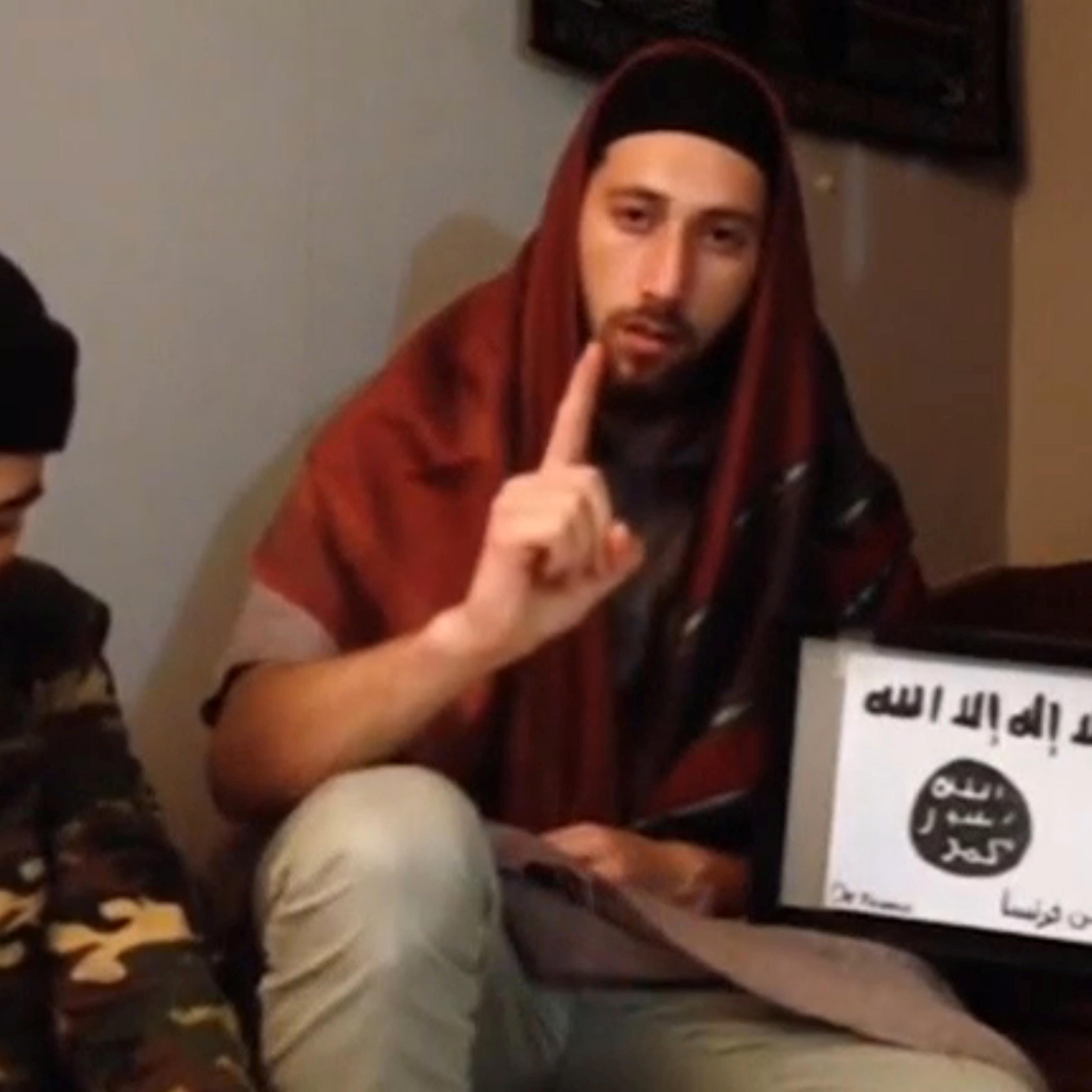 A still image taken from an undated video posted on social media shows two men that the Islamic State said were the attackers of a church in France seated on the ground at an unknown location