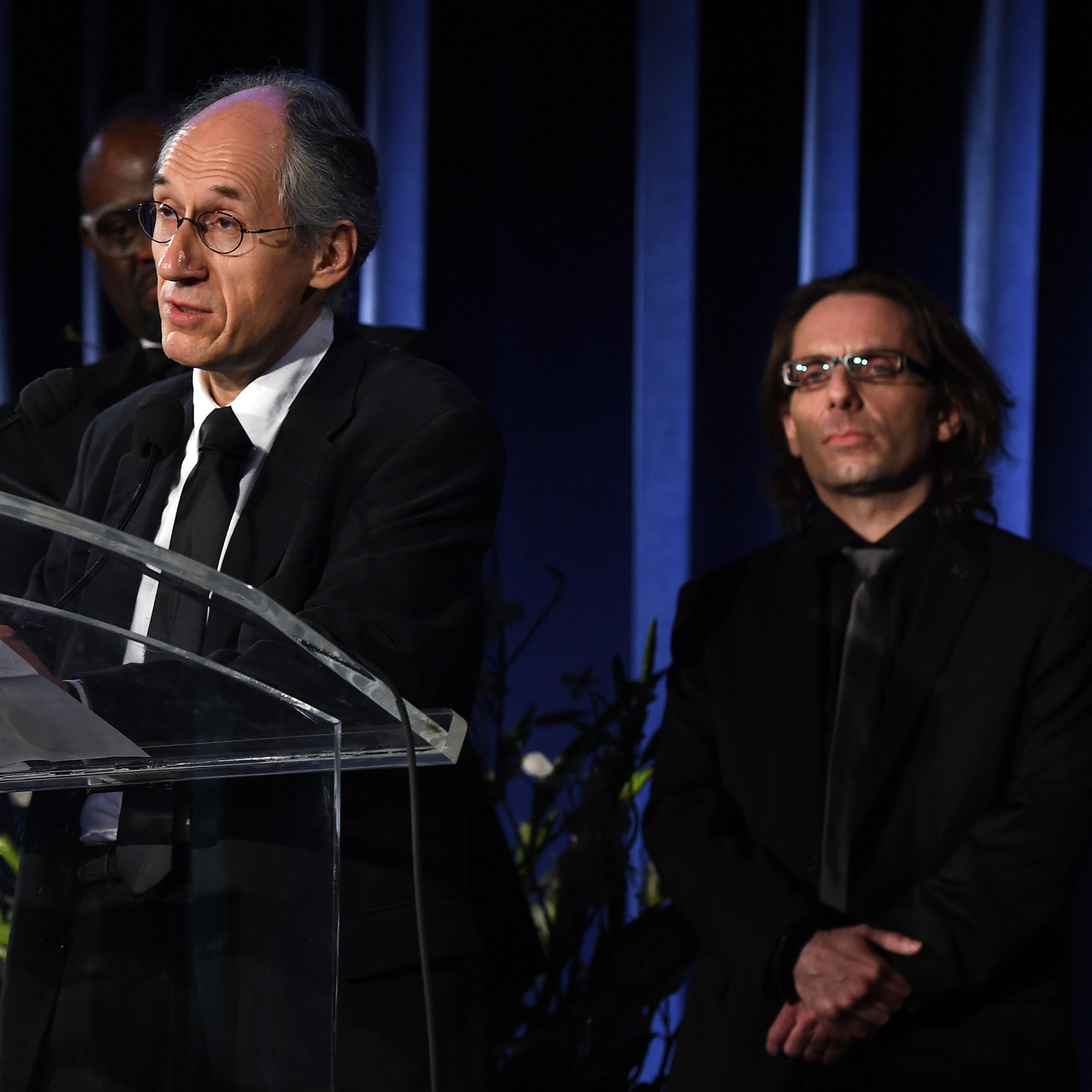 Gerard Biard (L), editor-in-chief of the Paris-based satirical weekly Charlie Hebdo, speaks before critic Jean-Baptiste Thoret (R) during the annual PEN American Center Literary Gala May 5, 2015 at the American Museum of Natural History in New York.