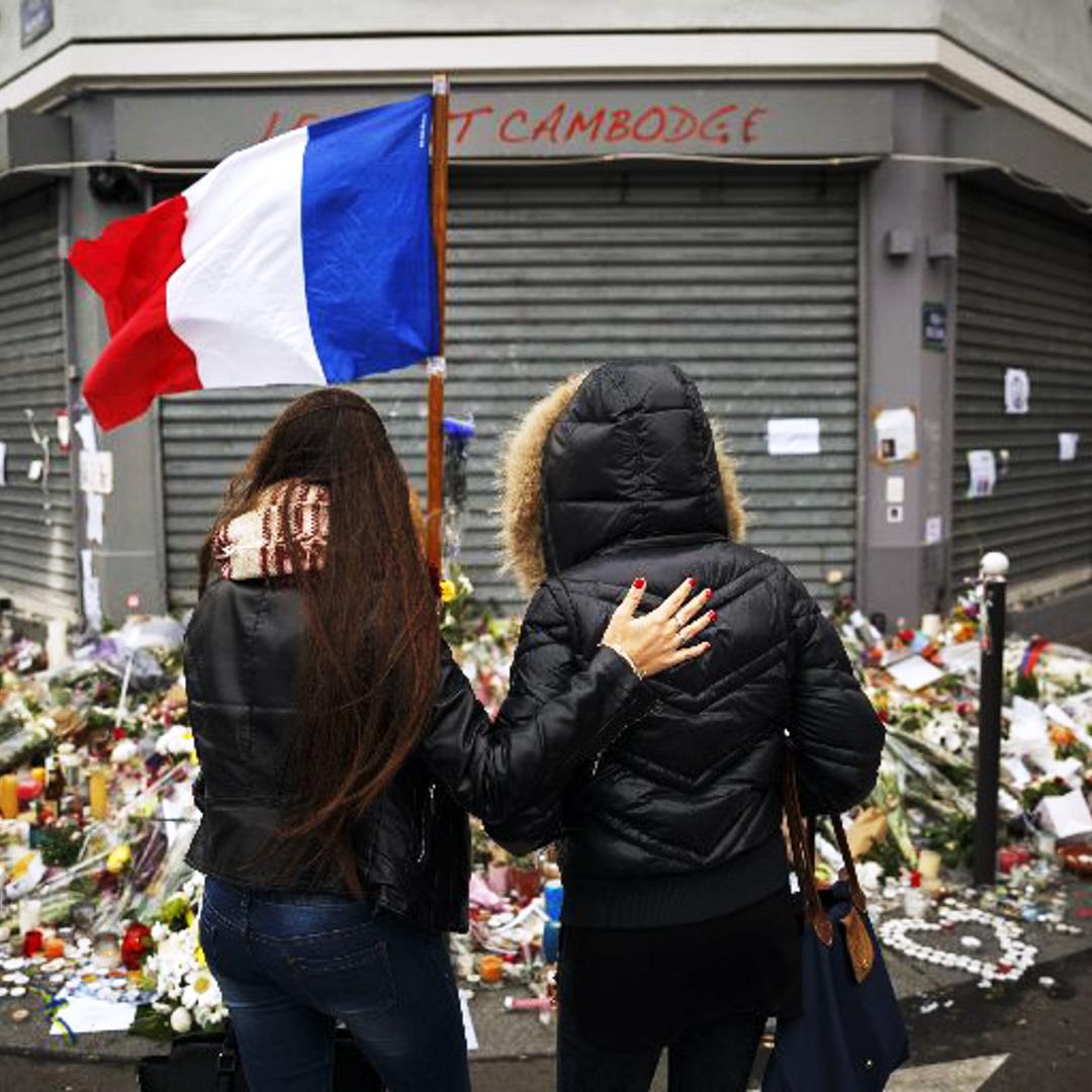 Two women stand outside the Petit Cambodge restaurant Tuesday, Nov. 17, 2015, at a site of last Friday's attacks in Paris.