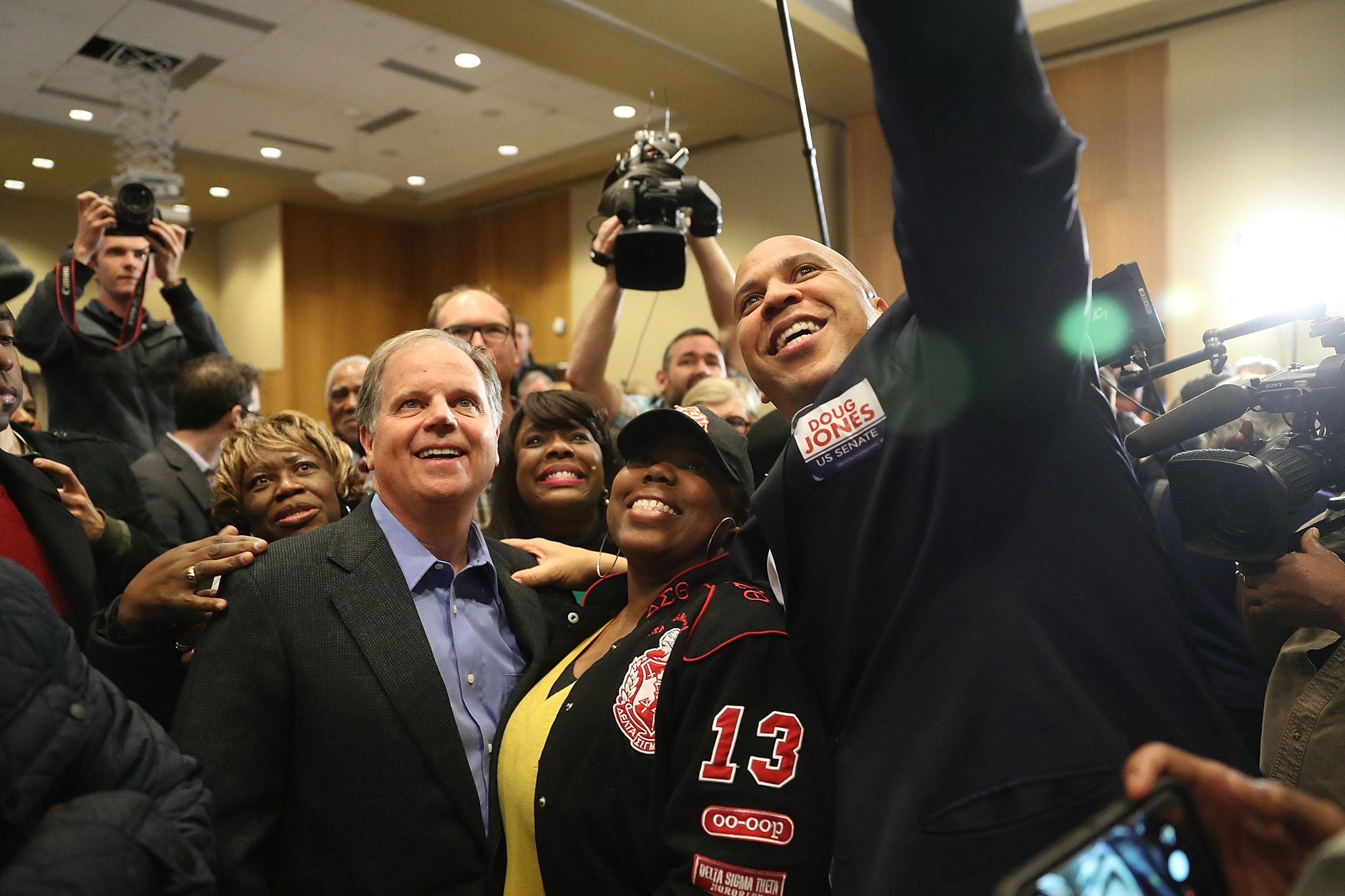 Democratic Senatorial candidate Doug Jones takes a group picture with Sen. Cory Booker (D-NJ) (R) and Rep. Terri Sewell (D-AL) (third from right) and supporters during a campaign event held at Alabama State University on December 9, 2017, in Montgomery, Alabama.