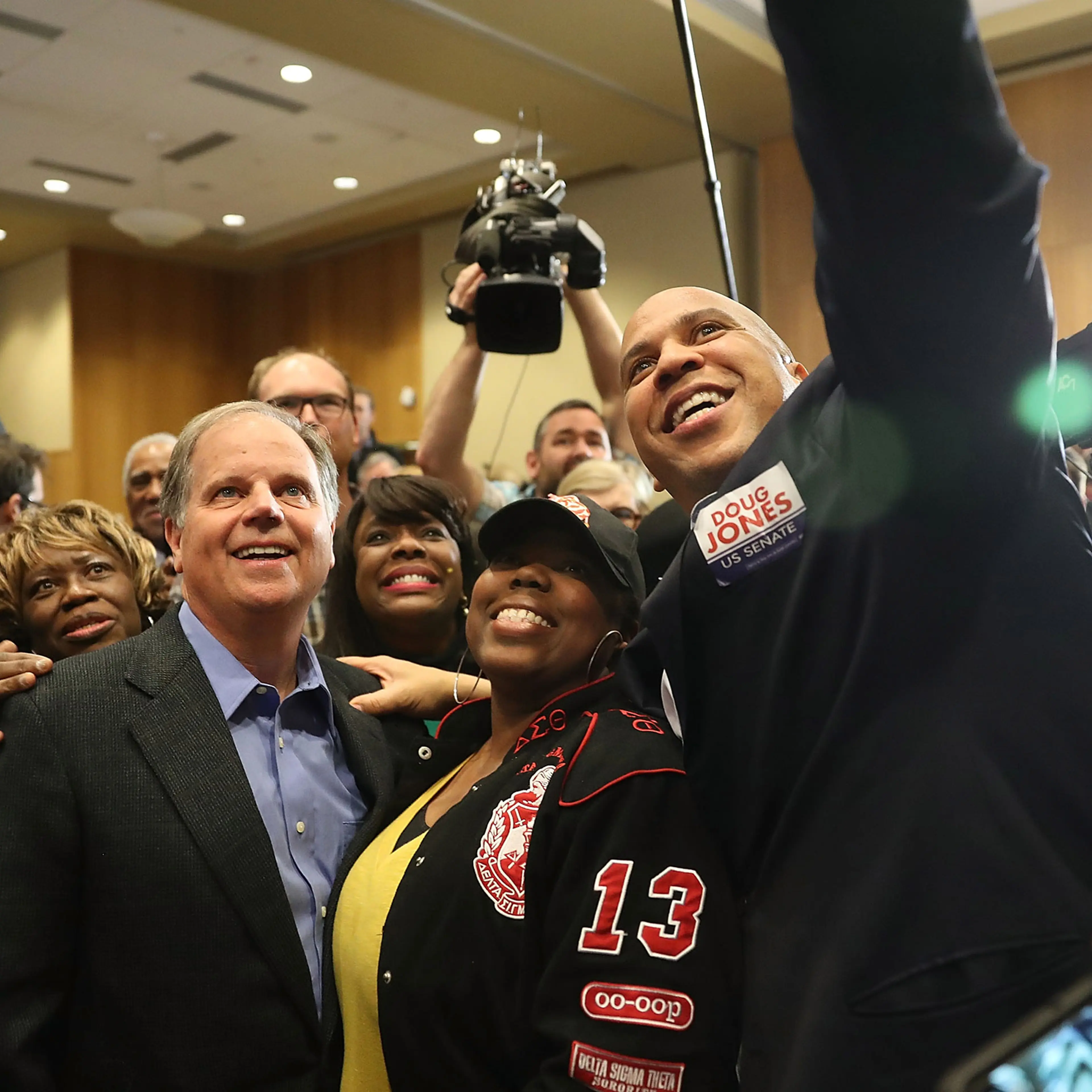 Democratic Senatorial candidate Doug Jones takes a group picture with Sen. Cory Booker (D-NJ) (R) and Rep. Terri Sewell (D-AL) (third from right) and supporters during a campaign event held at Alabama State University on December 9, 2017, in Montgomery, Alabama.