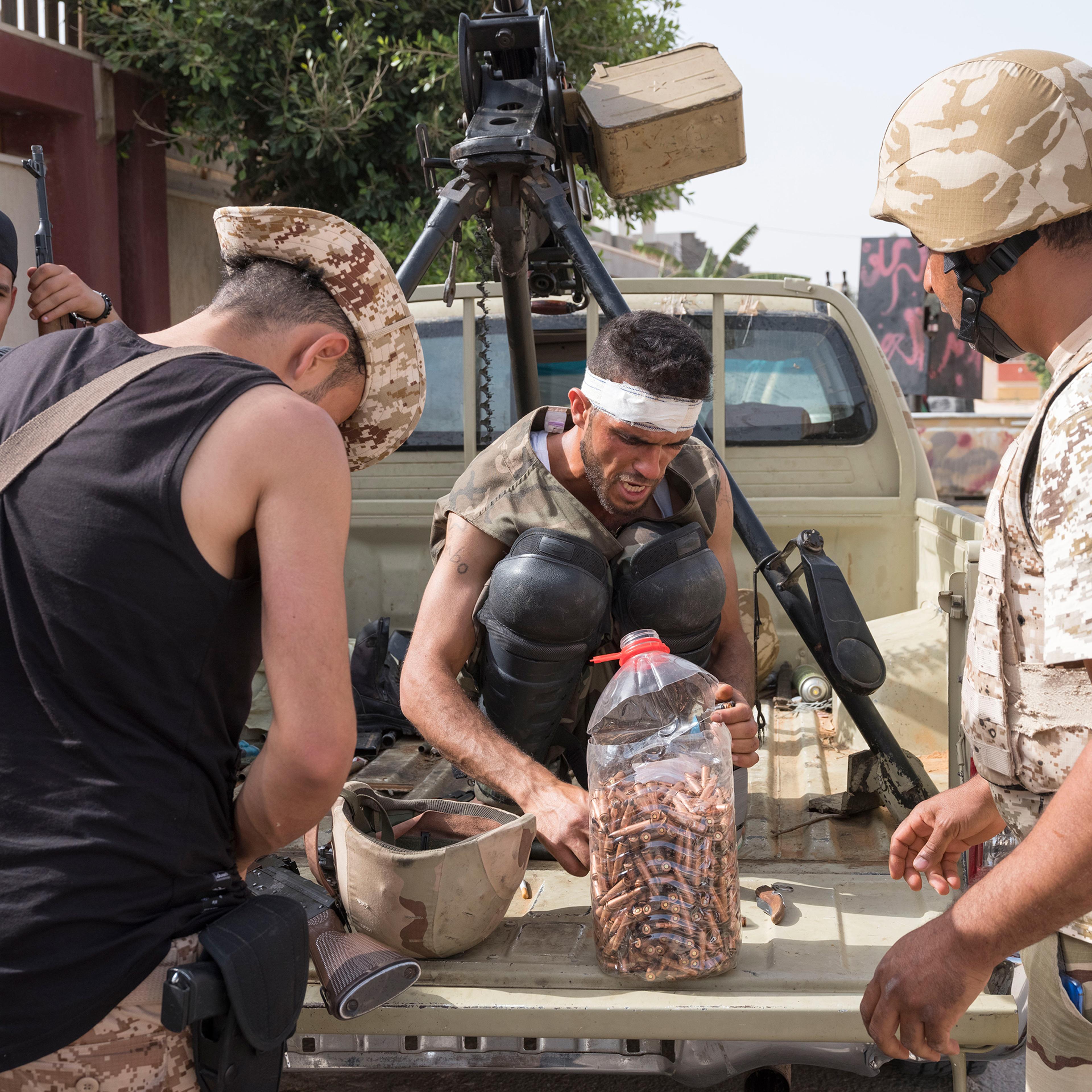 Forces allied with the U.N.-backed government reload ammo on the frontline outside Tripoli in April 2019.