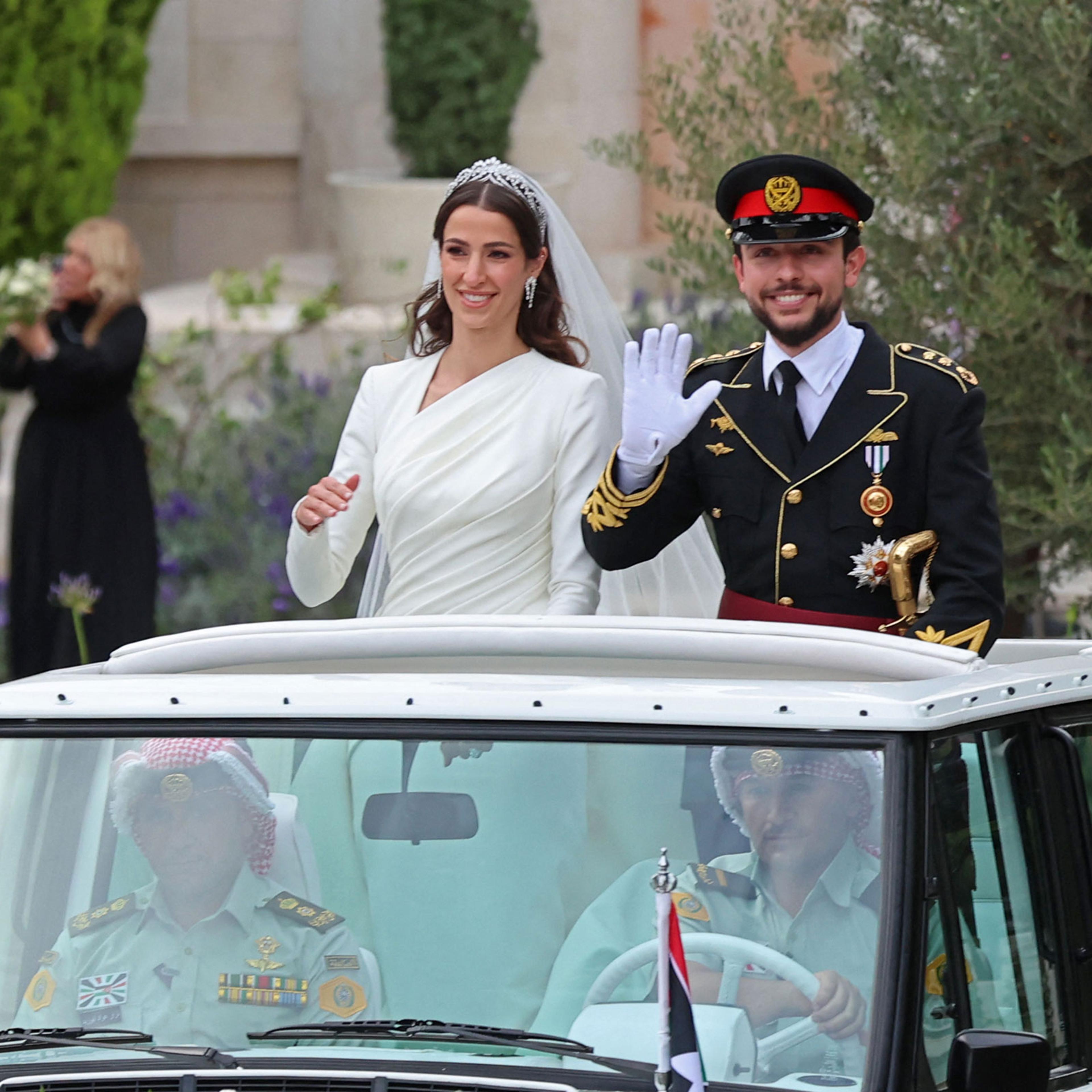 Jordan’s Crown Prince Hussein and his wife, Rajwa al-Seif, standing in a car following their wedding