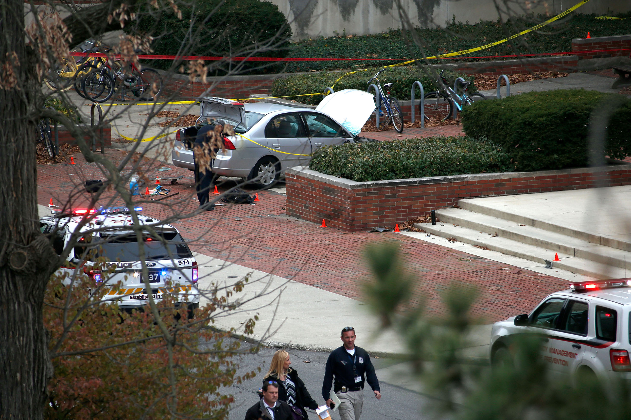 Police investigate the scene where an individual used a car to crash into a group of students outside of Watts Hall on the Ohio State University campus on November 28, 2016 in Columbus.