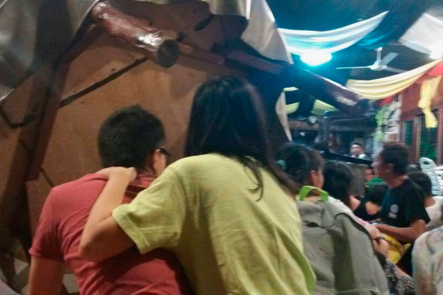 Tourists take cover on the floor next to an overturned table as armed men occupy a hotel in Sabah, April 2, 2014. 