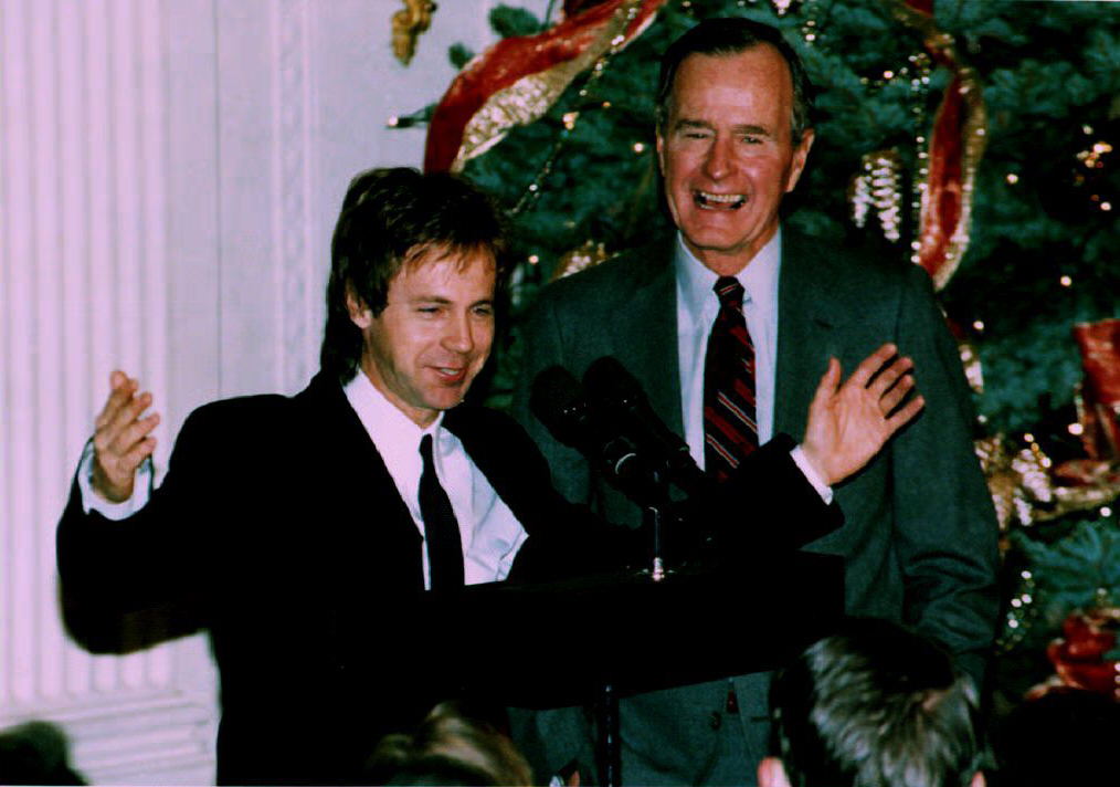 U. S. President George Bush (R) watches as comedia