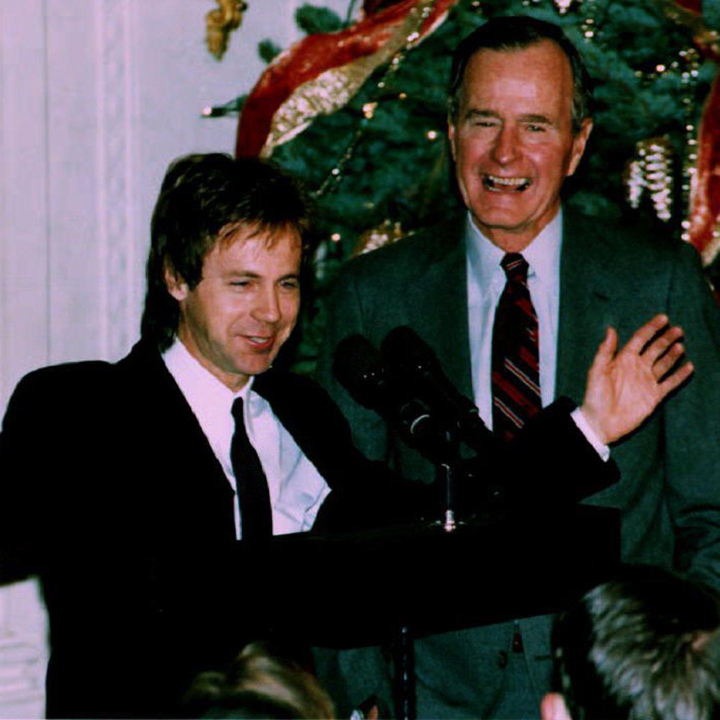U. S. President George Bush (R) watches as comedia