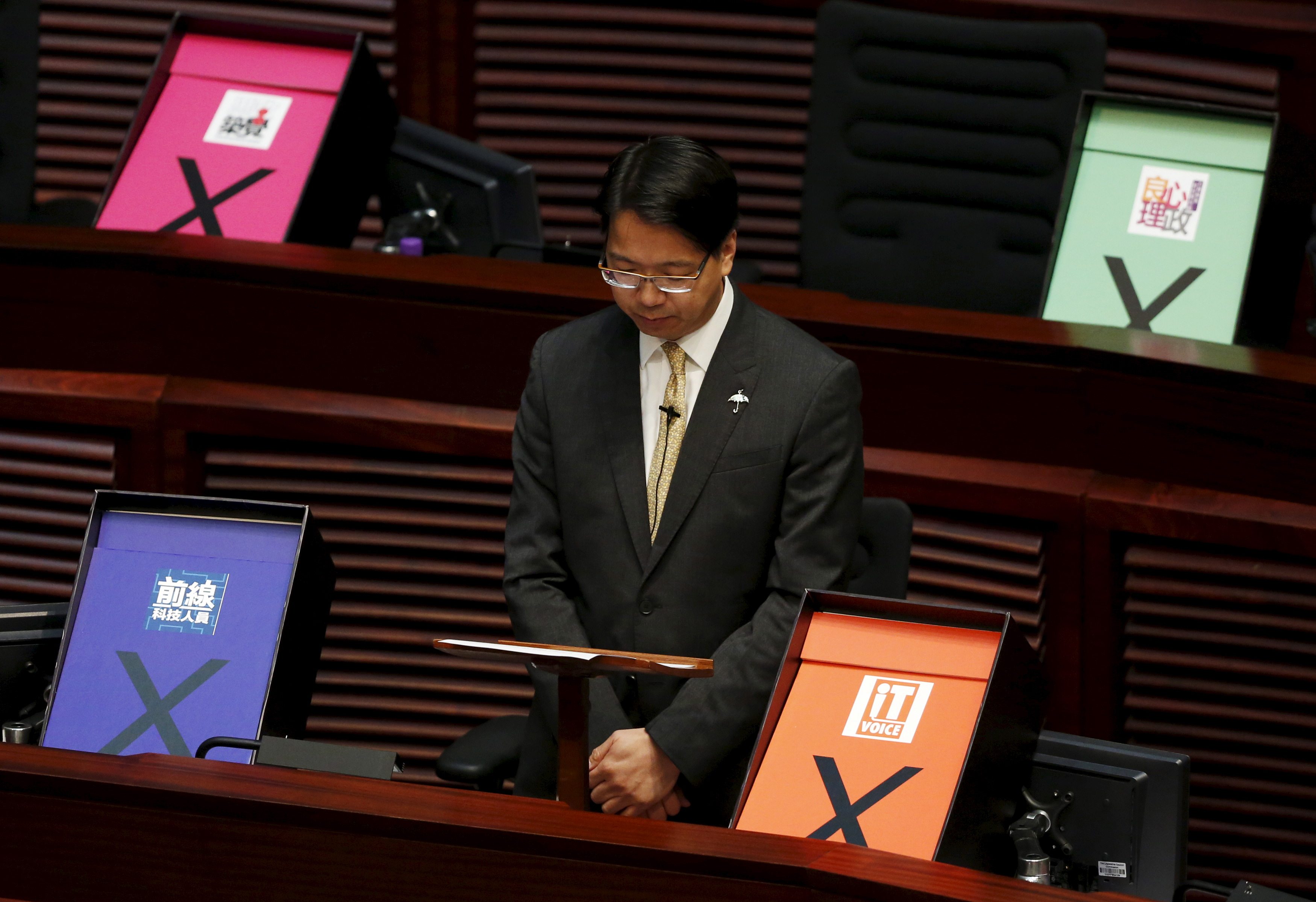 Pro-democracy lawmaker and I.T. advocate Mok is surrounded by veto signs during his speech at the Legislative Council meeting in Hong Kong
