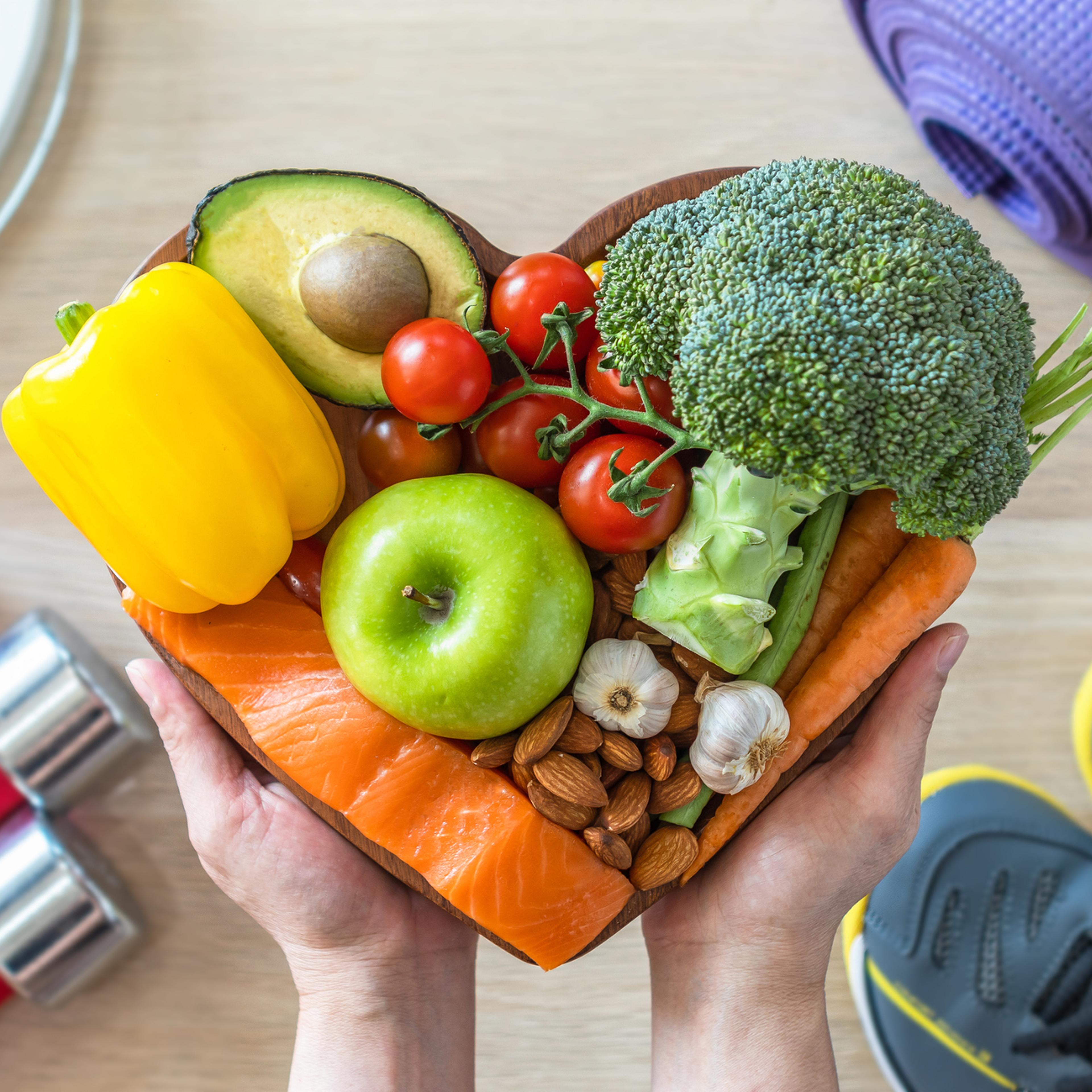 Healthy lifestyle on ketogenic diet, eating clean keto food good health dietary in heart dish with aerobic body exercise, gym workout training class , weight scale and sports shoes in fitness center